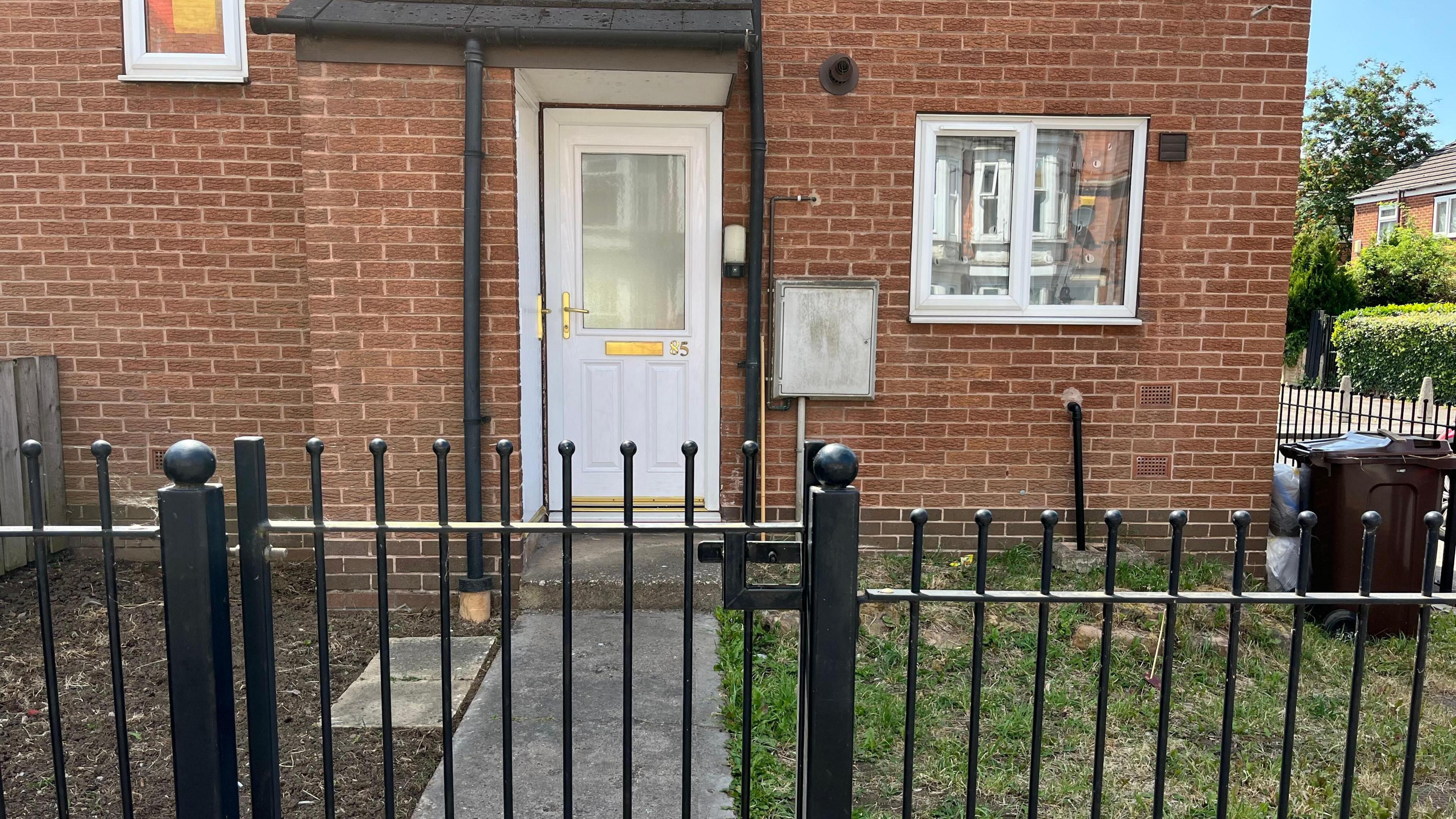 The front of the house on Hartley Road where the pair lived. A white front door and black railings around the outside