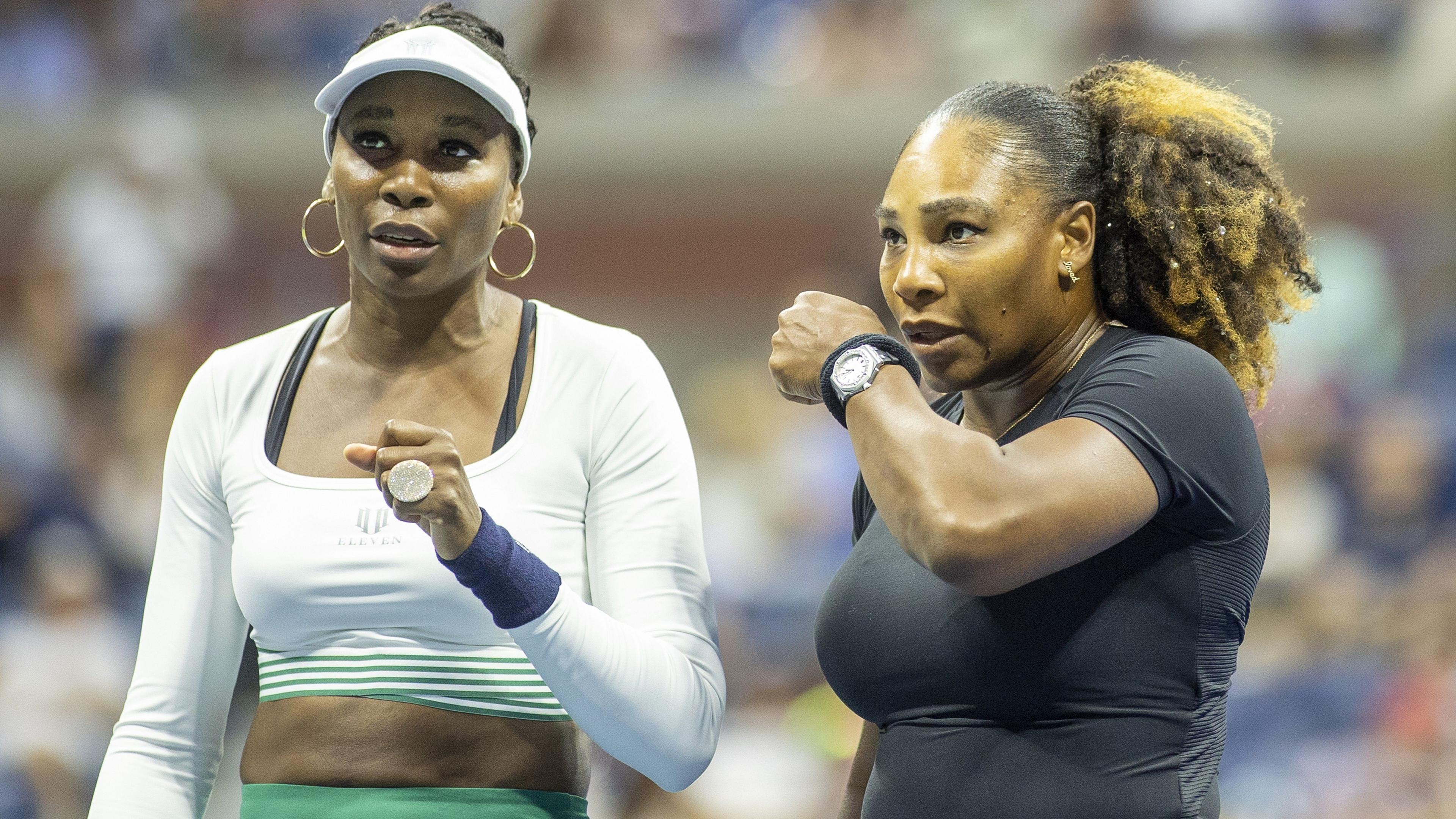 Venus Williams (left) speaks to Serena Williams during their US Open first-round doubles match in 2022