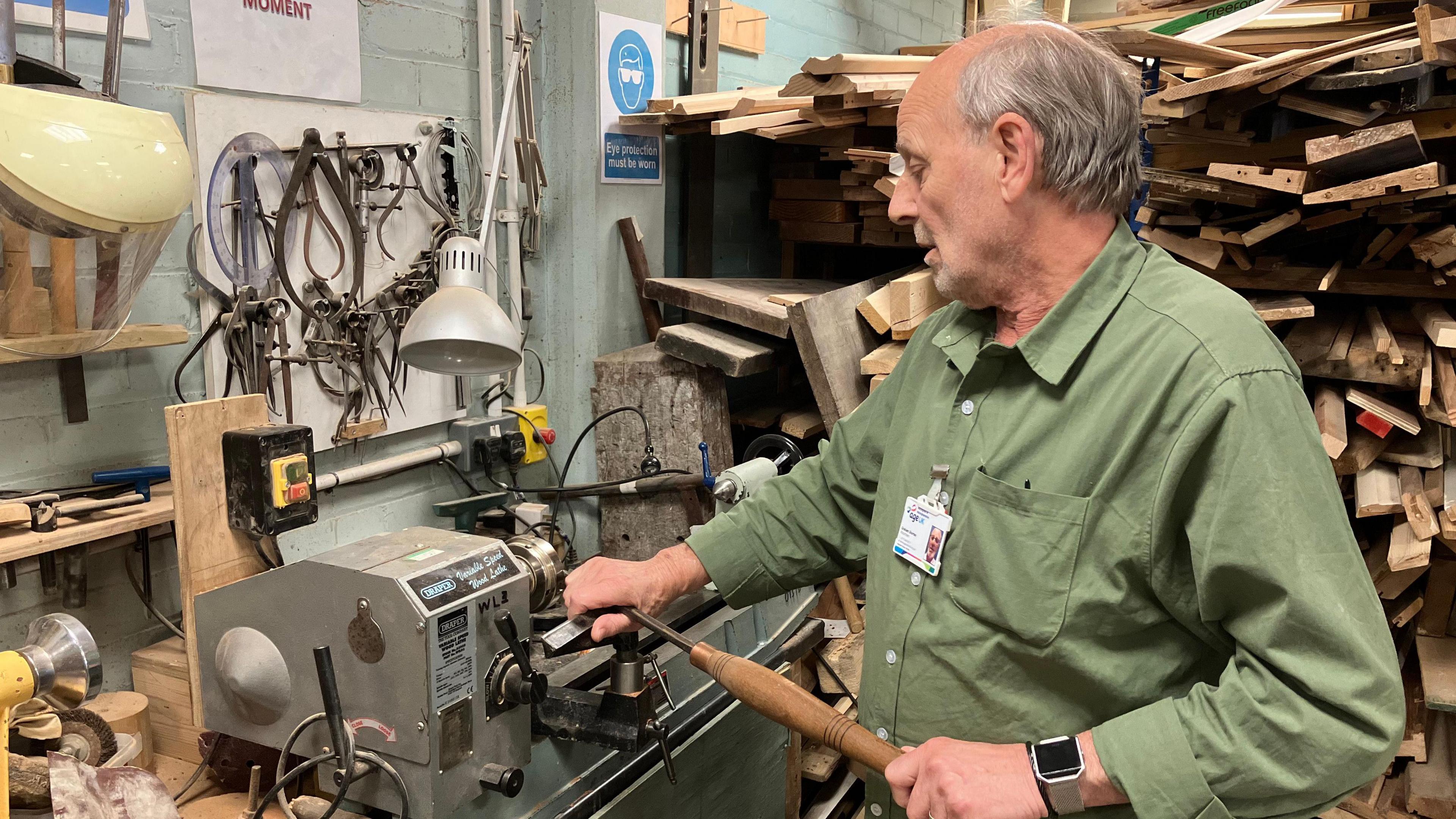 Man on a woodworking lathe