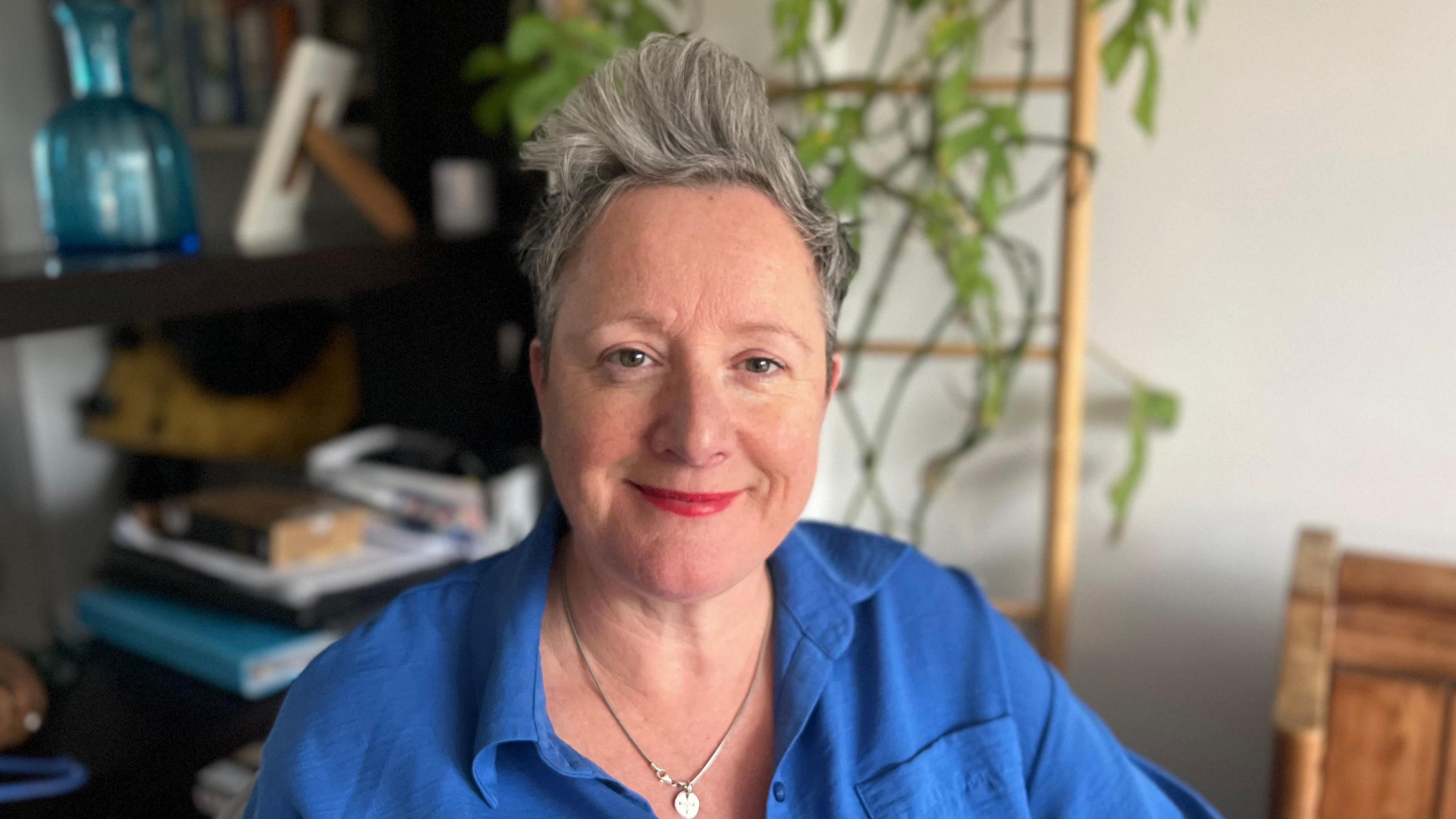 Jane Griffiths is the CEO of Capa First Response in Sussex which runs support groups for parents all over the country. She's is sitting in her office, wearing a blue shirt.