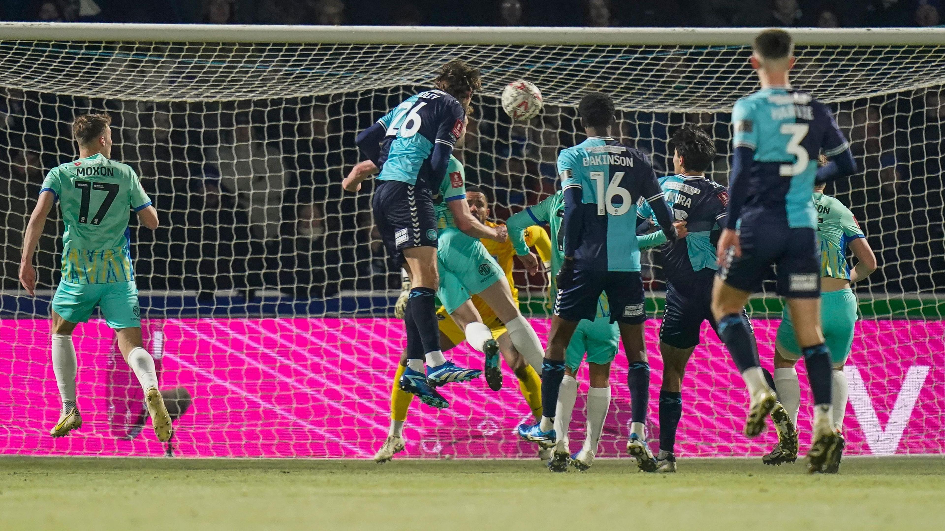 Sonny Bradley heading home Wycombe's second goal against Portsmouth