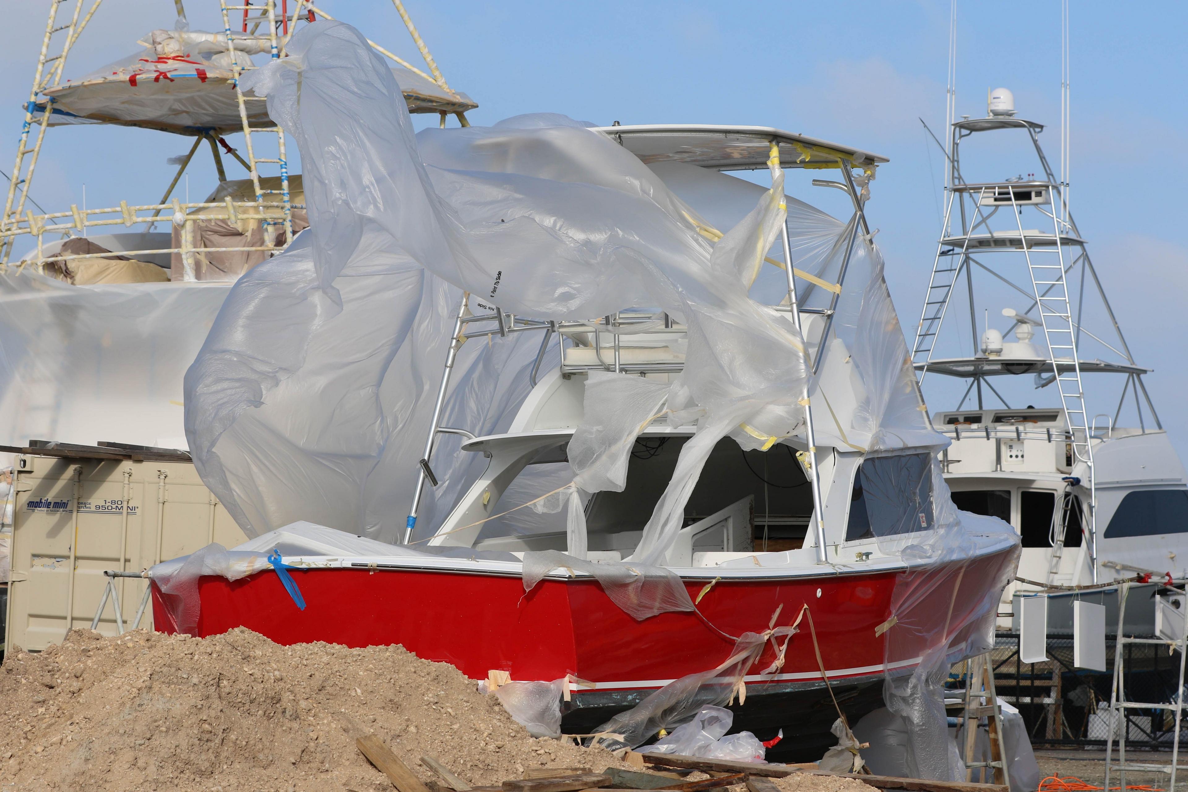 A plastic cover on a ship in dock blows in the wind