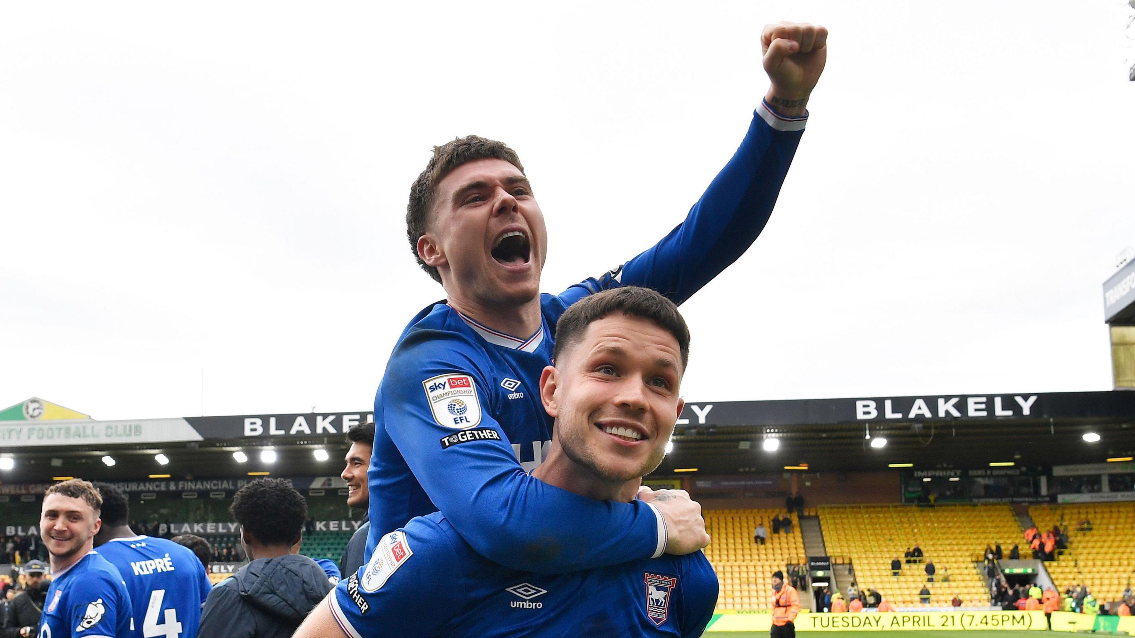 George Hirst with Leif Davis on his back after Ipswich won the derby against Norwich at Carrow Road