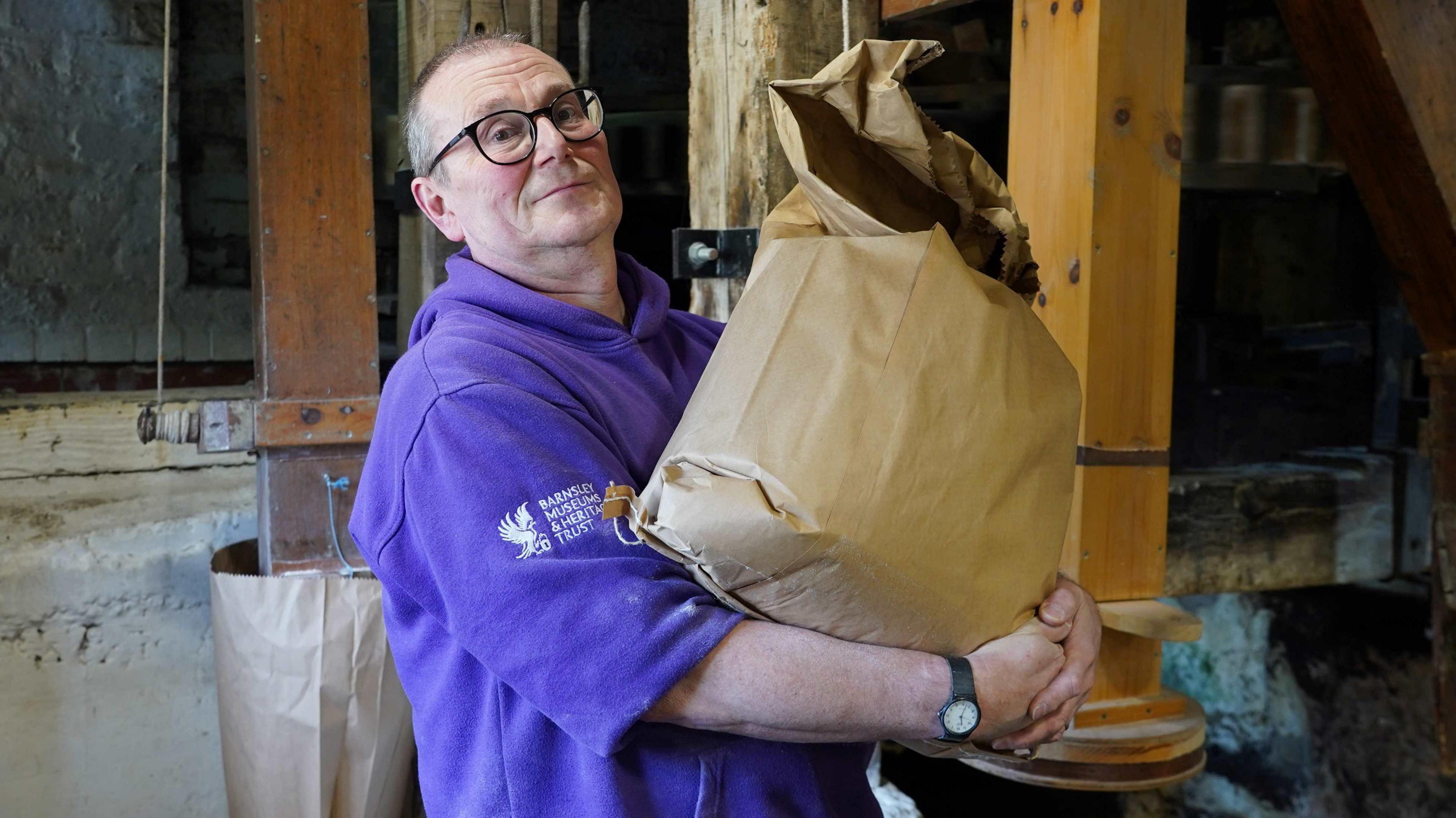 Miller Simon Dodd from Worsbrough Mill holding a bag of milled flour