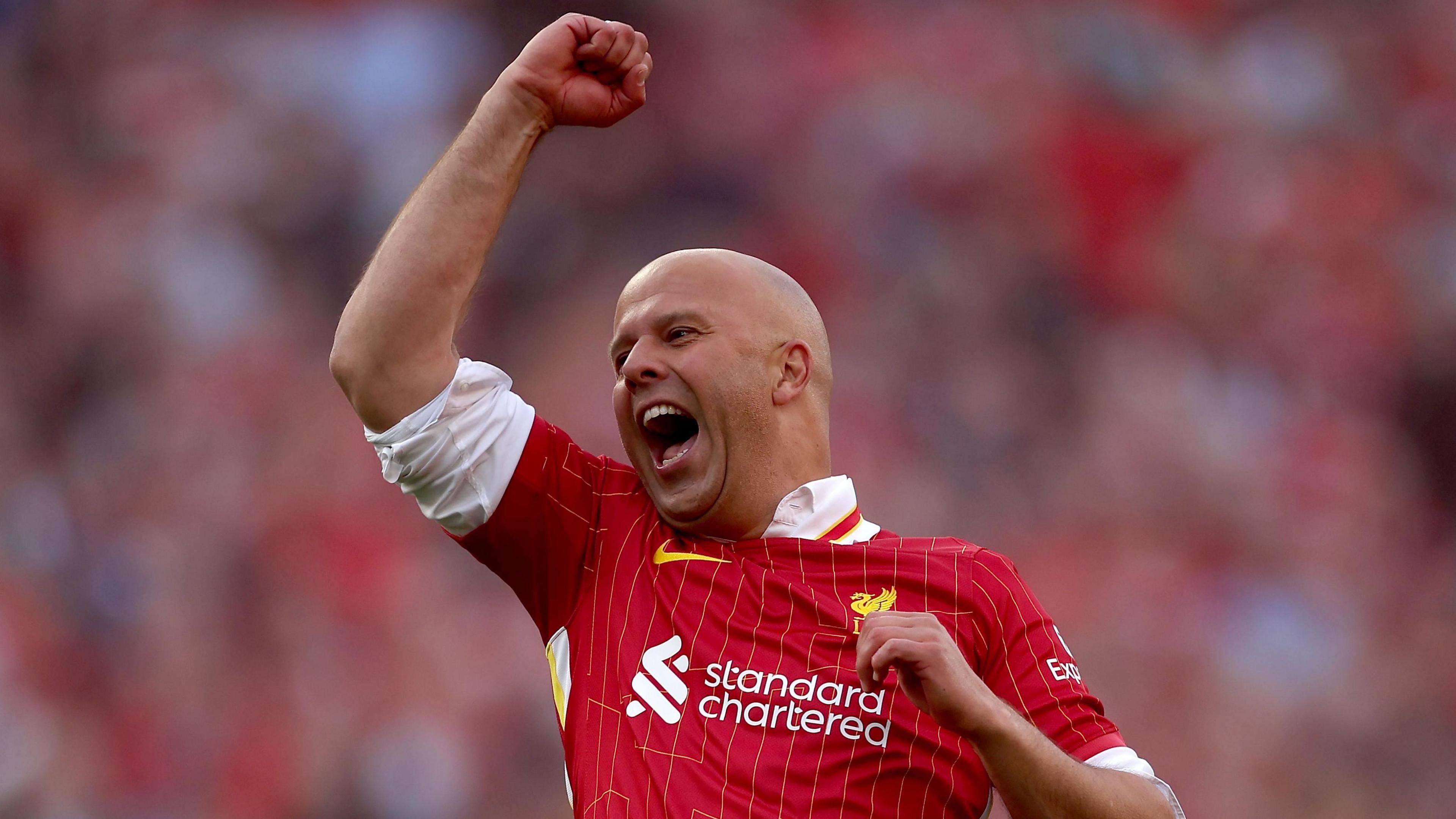 Arne Slot celebrates in front of The Kop after Liverpool won their 20th title.