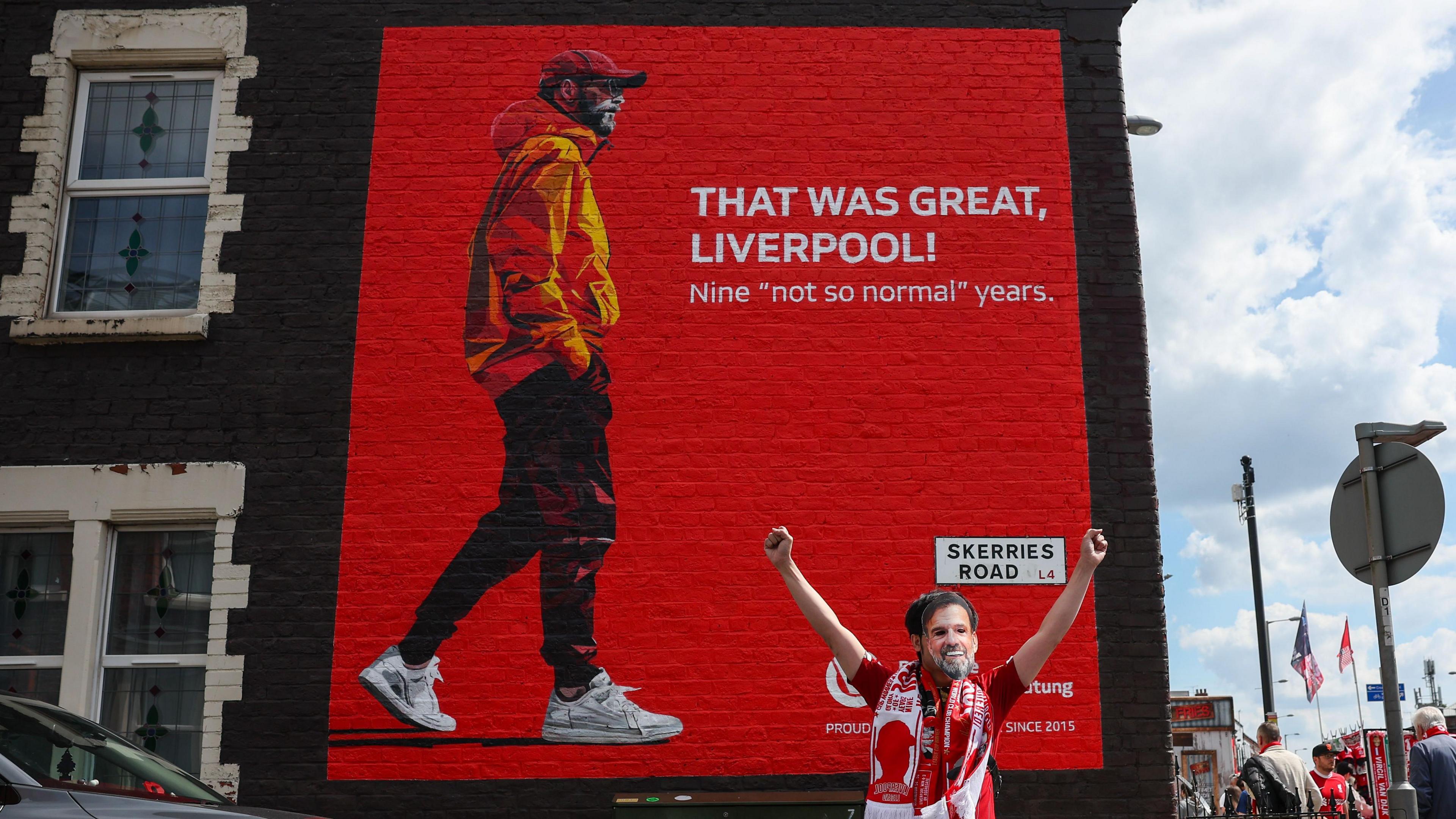 Fan in Klopp mask outside the new Jurgen Klopp mural