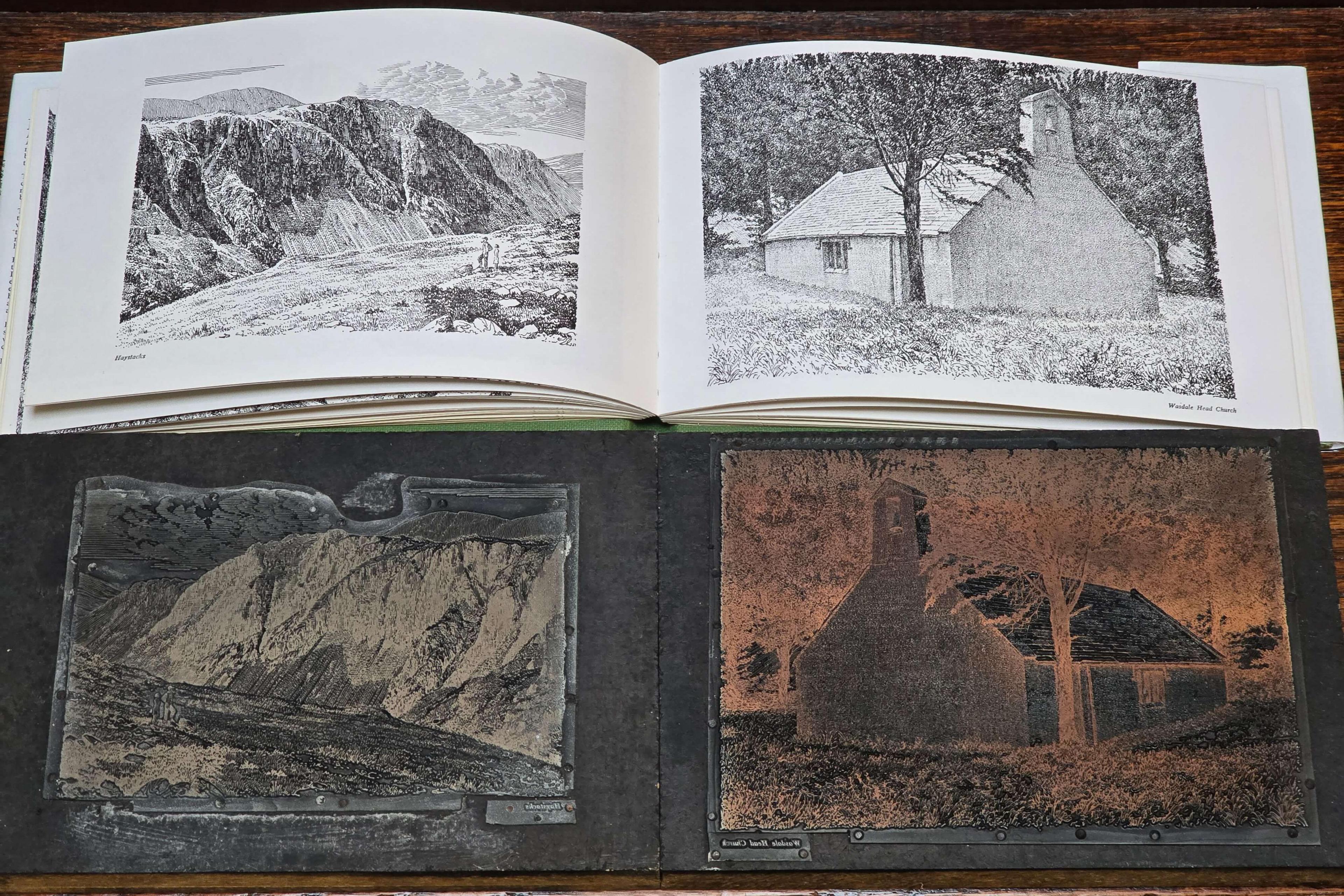 A copy of Wainright's Fellwanderer book, opened to show two black-and-white pen-lined drawings. Below it are the two copper plates used to produce the images as part of the printing process.