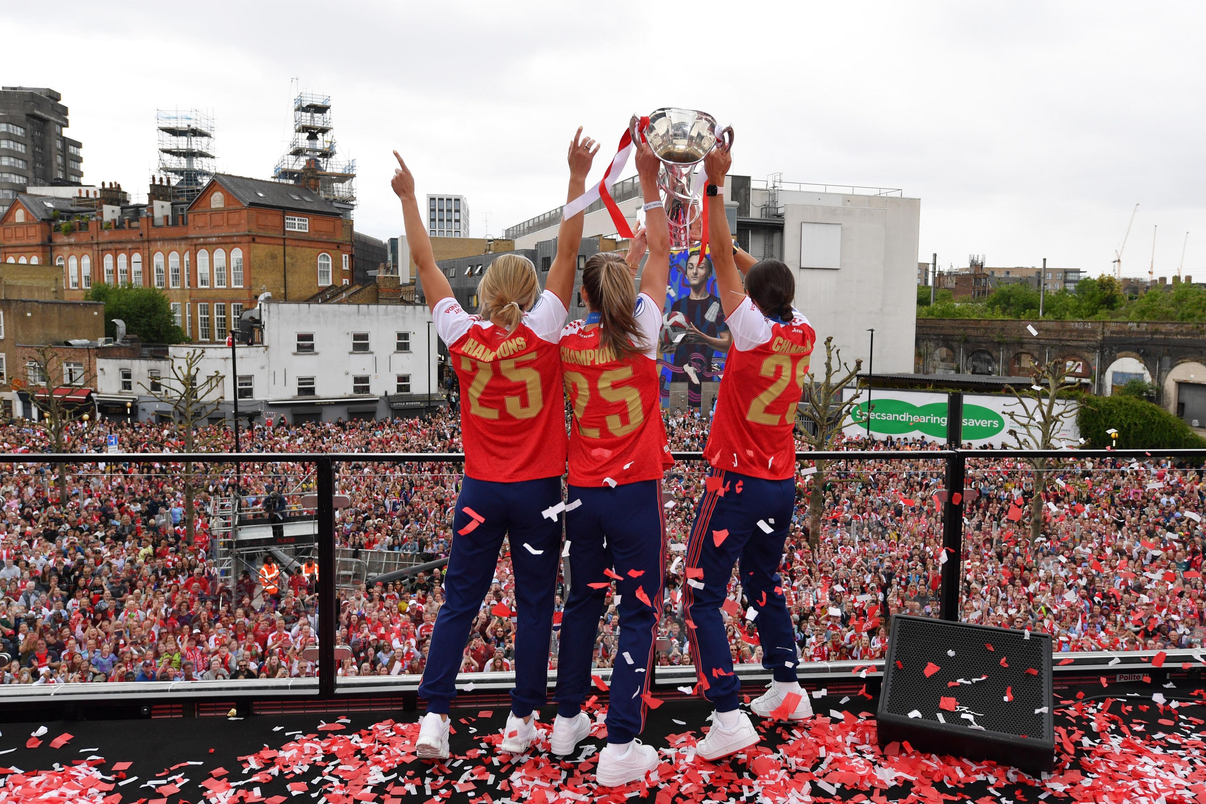 Arsenal players lift the trophy