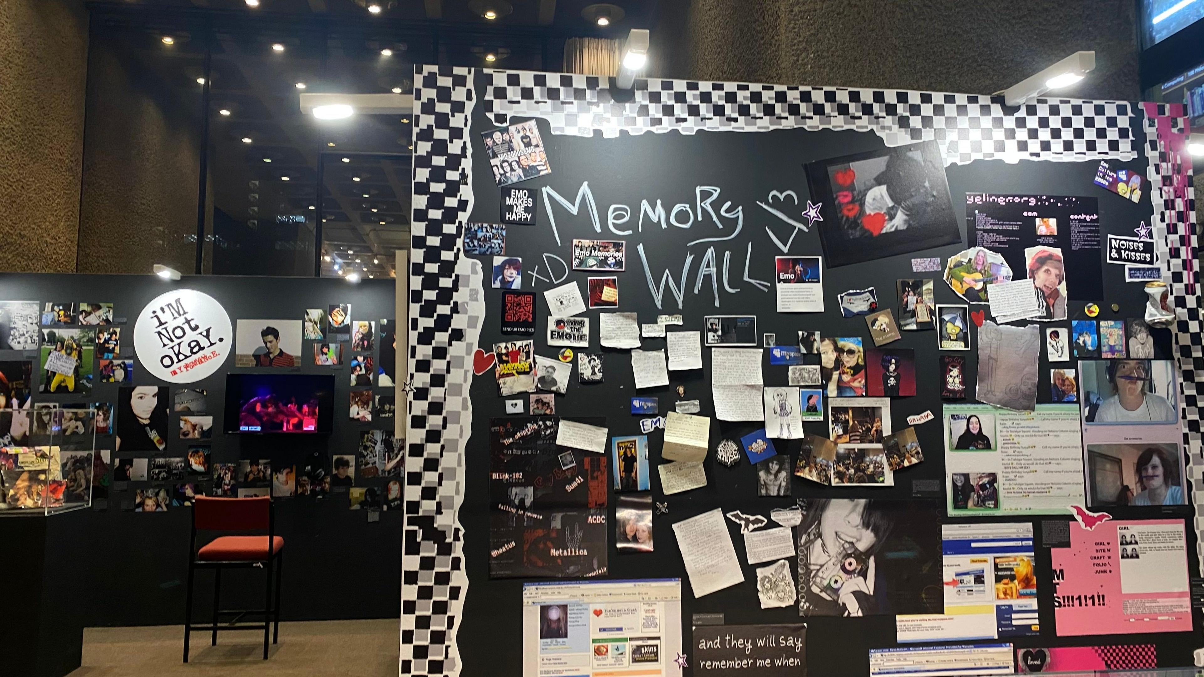 Two walls of the exhibition. The wall on the left has 'I'm not okay' written on it and images of emo people. To the right is the memory wall with screenshots of websites, social medias, memes and notes left by attendees. 