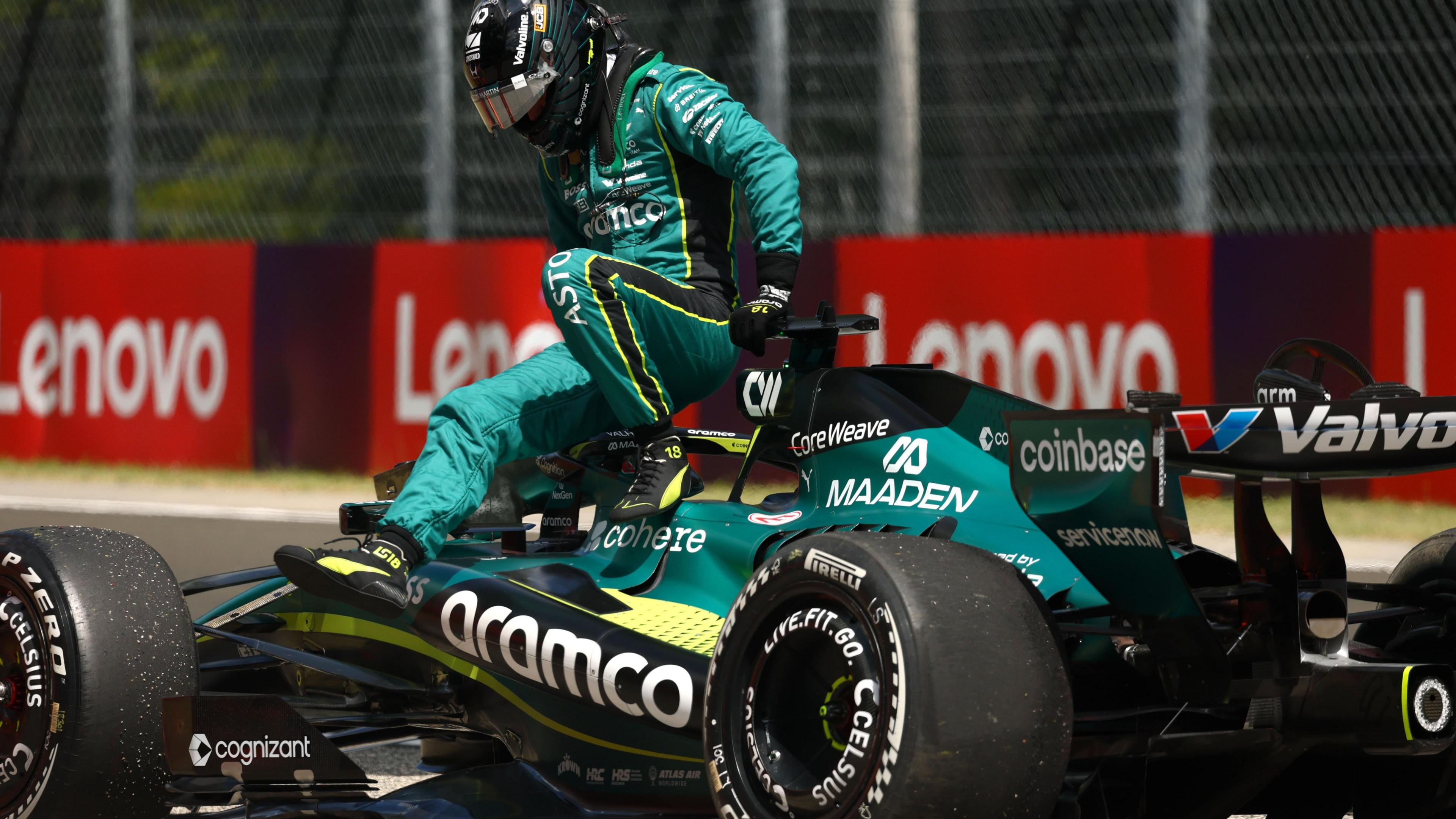 Lance Stroll climbs out of his Aston Martin after it suffered a suspension failure during Hungarian Grand Prix first practice