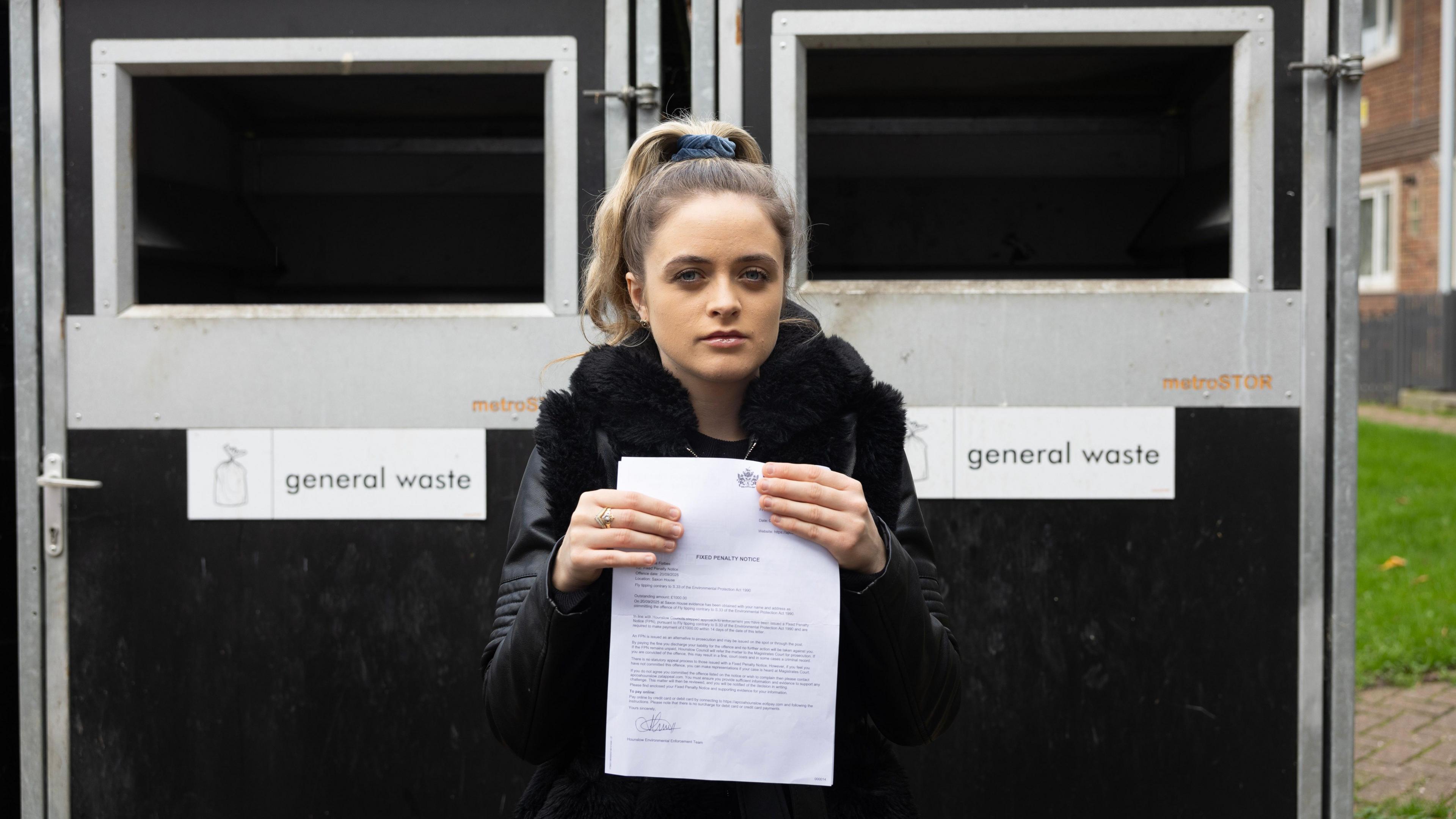loretta stands holding her notice letter