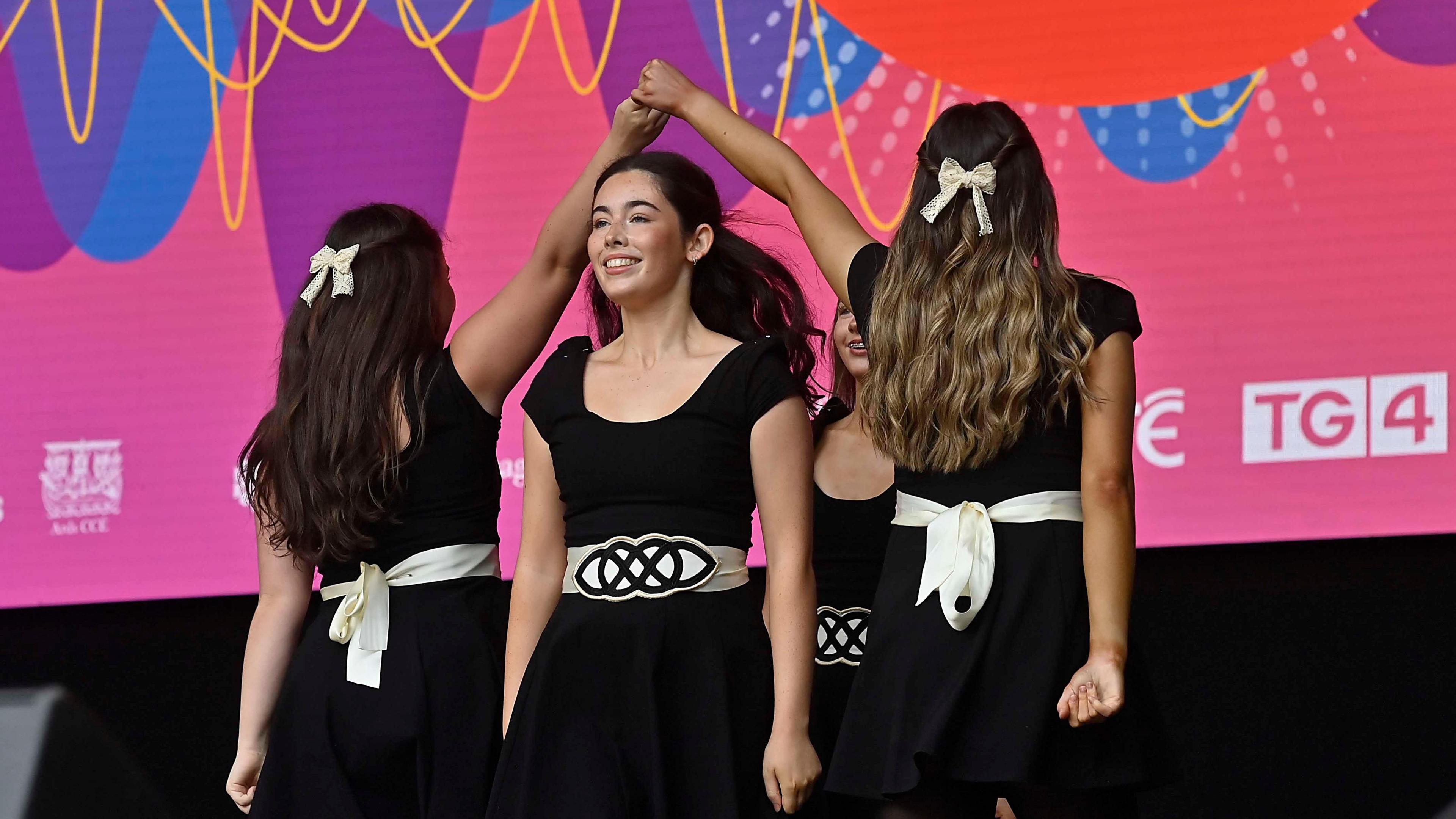 Four women in black outfits Irish dancing