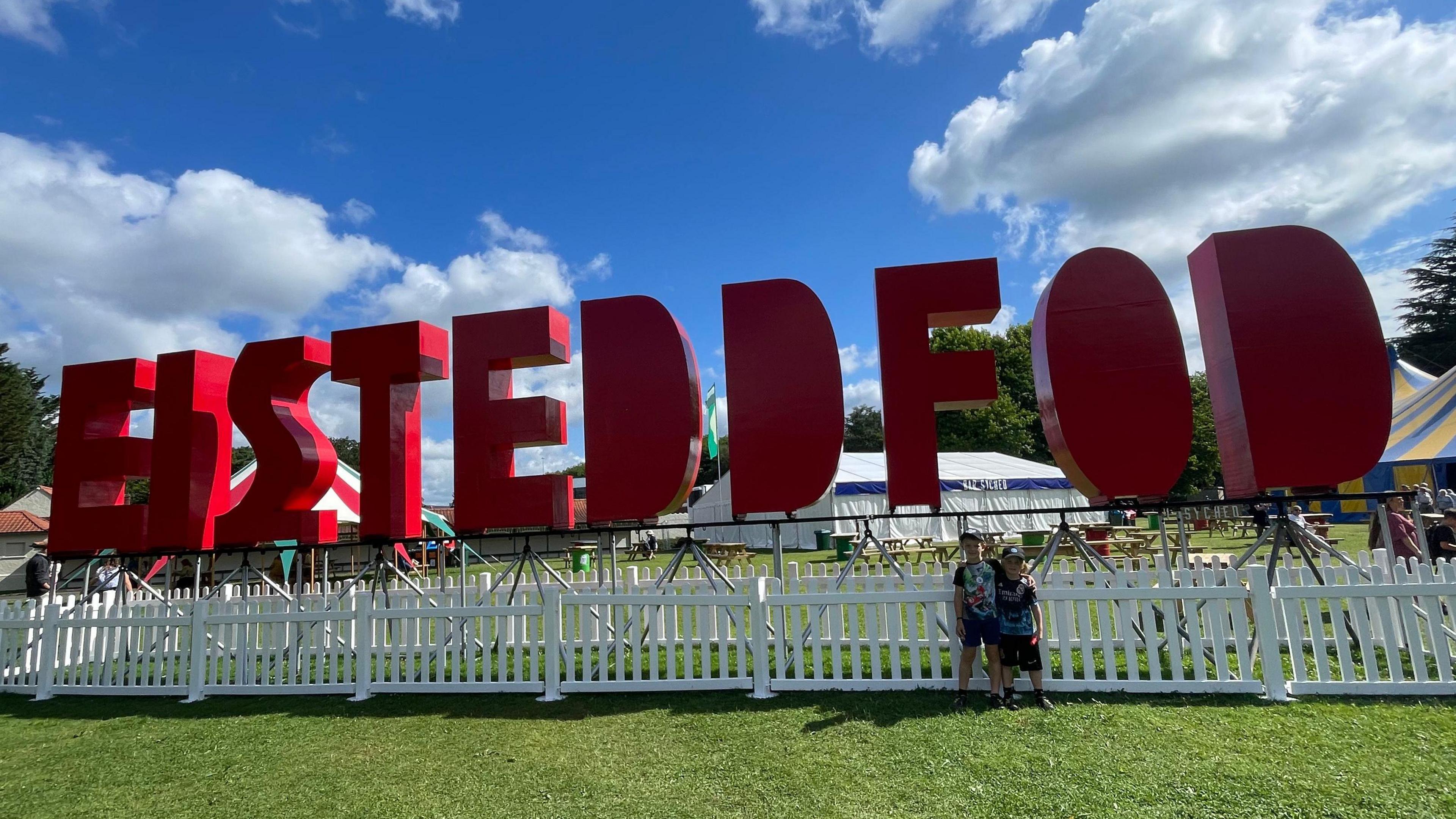 Harry, 7, and Freddie, 5, outside the National Eisteddfod sign in Pontypridd