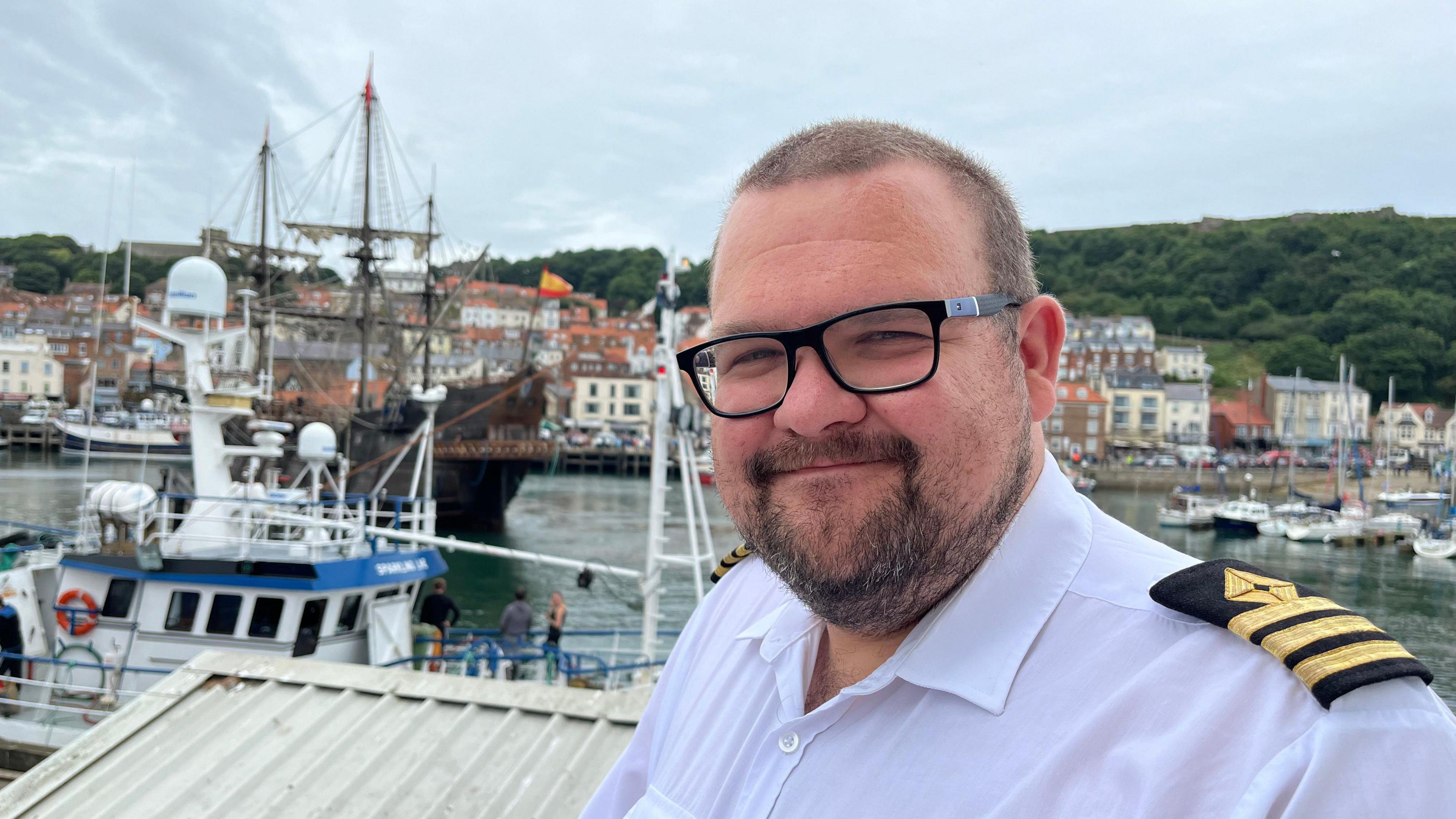 An image of Harbour master James Buck wearing a white shirt with black and gold epaulettes