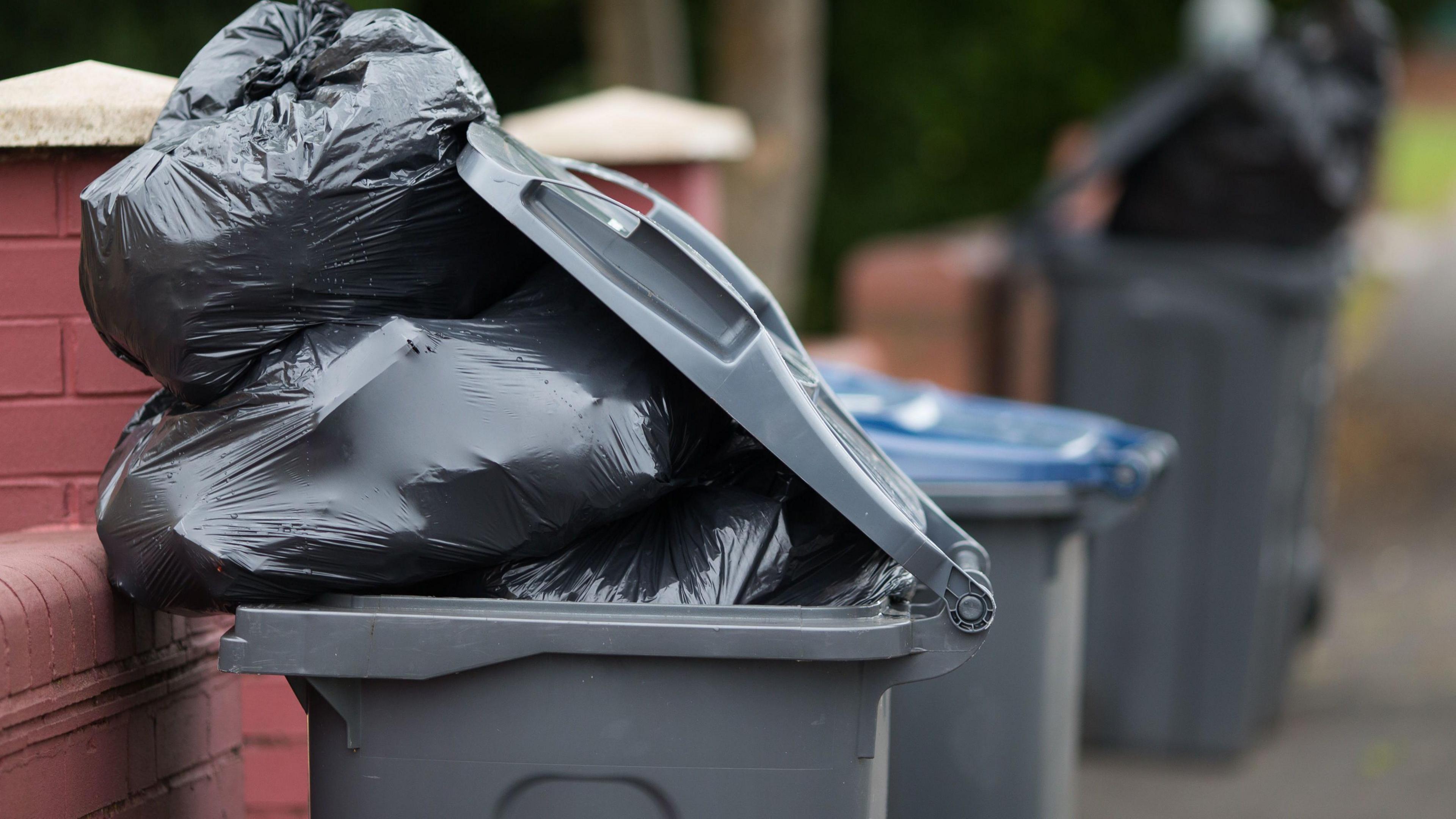 Unemptied rubbish bins on a street