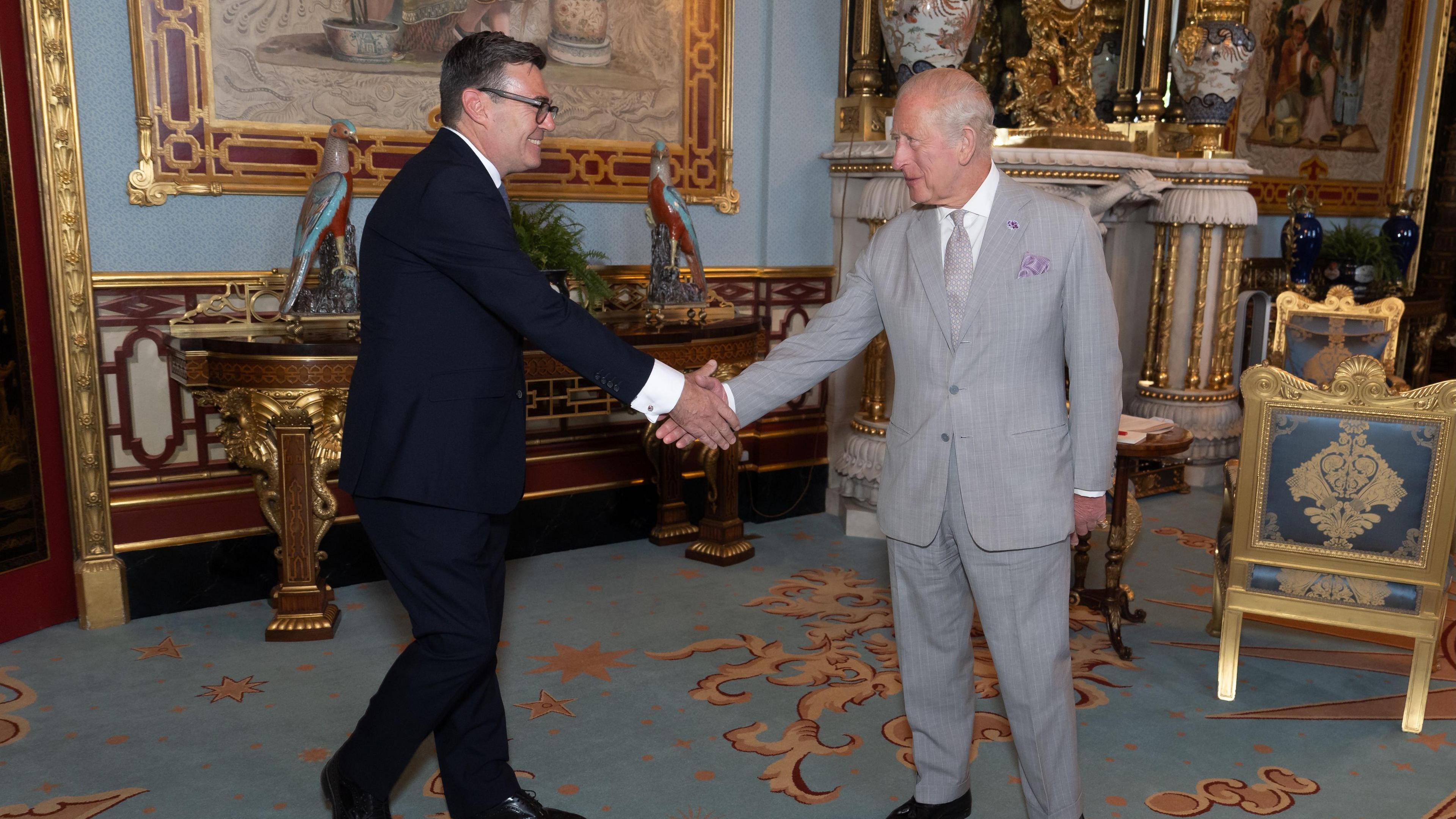 Andy Burnham shaking hands with King Charles