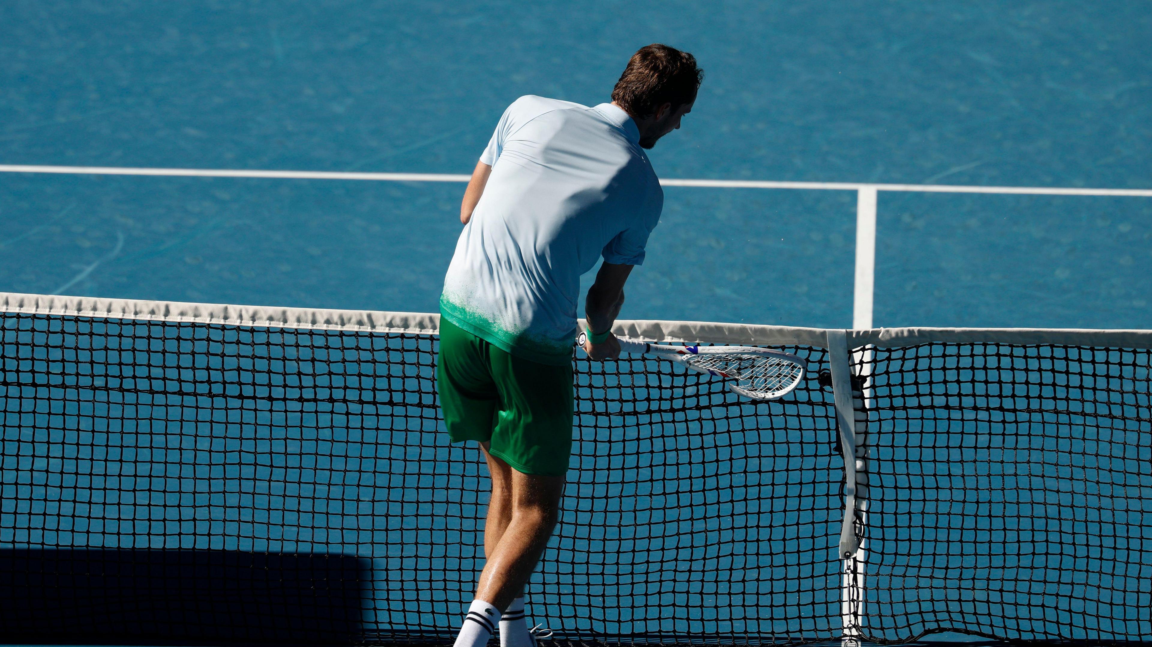 Daniil Medvedev smashes his racquet into the net camera