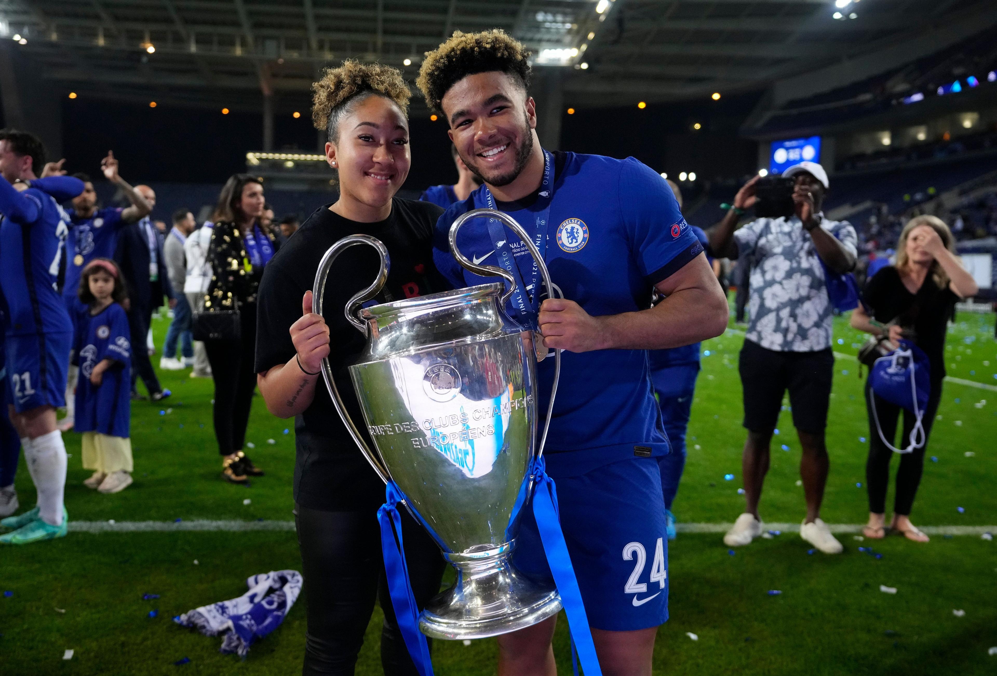 Reece James, with his sister Lauren James, as the pair hold the Champion's League trophy during on-pitch celebrations