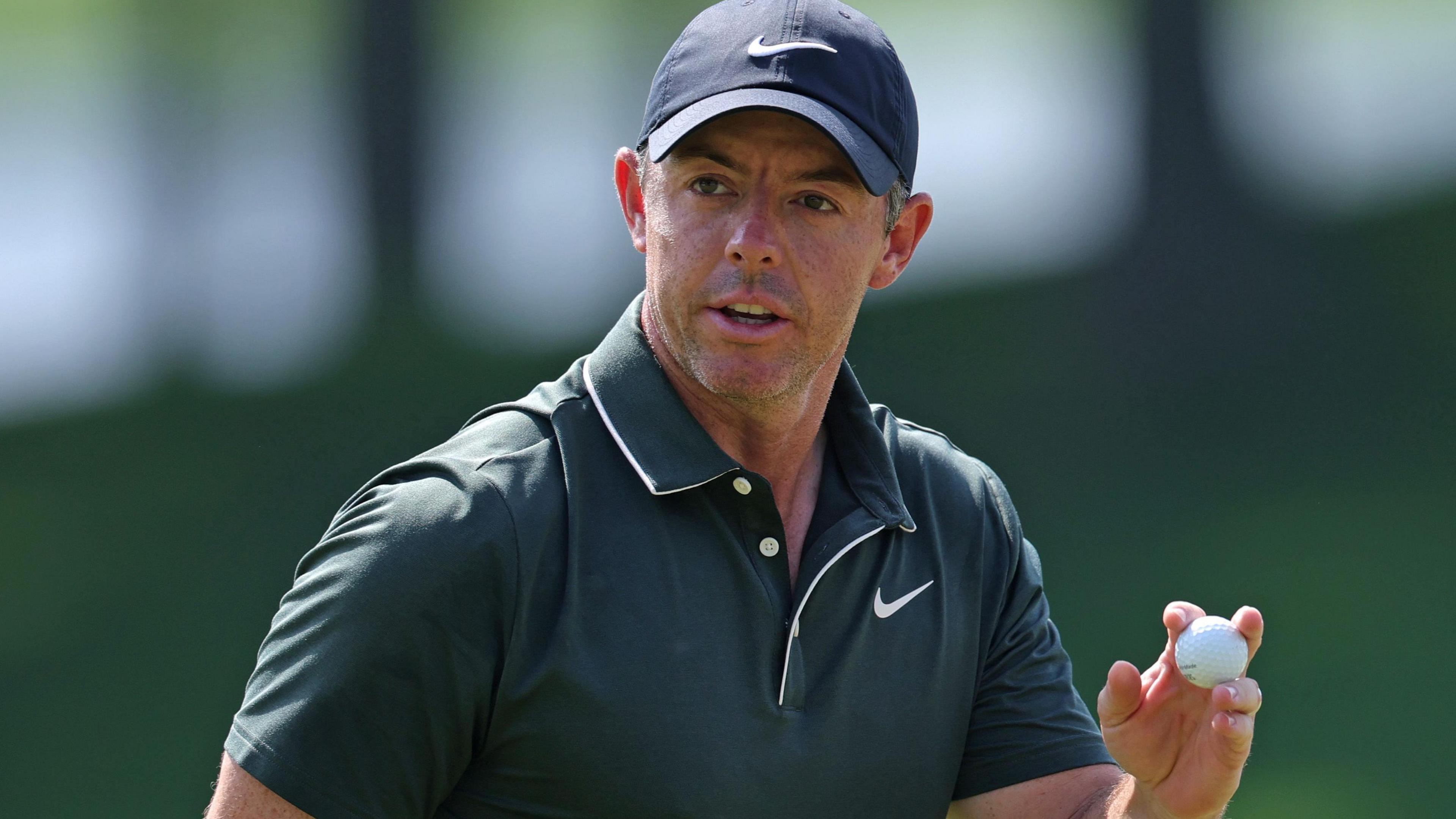 Rory McIlroy holds a golf ball