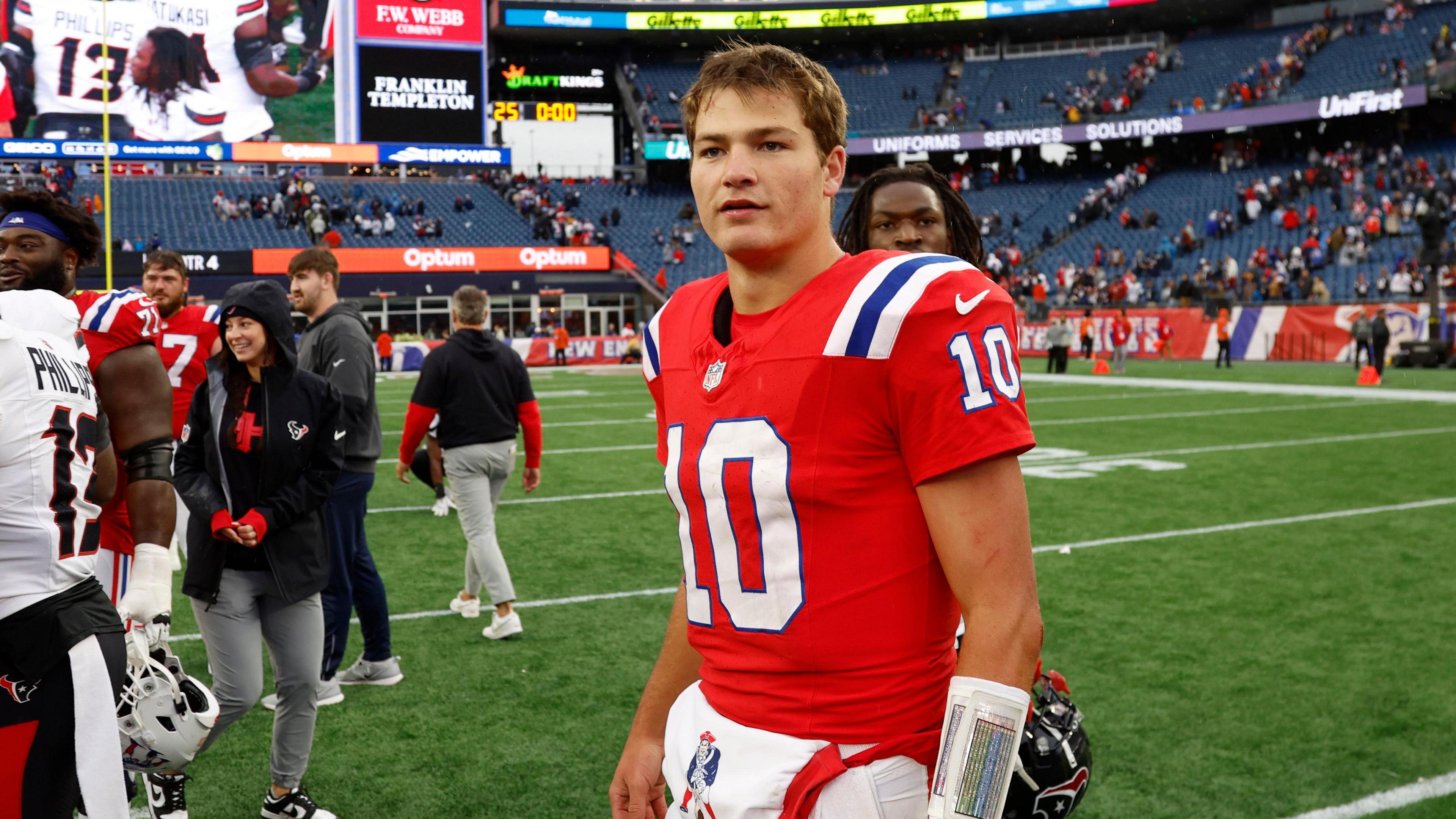 New England Patriots quarterback Drake Maye on the field after a game in the NFL