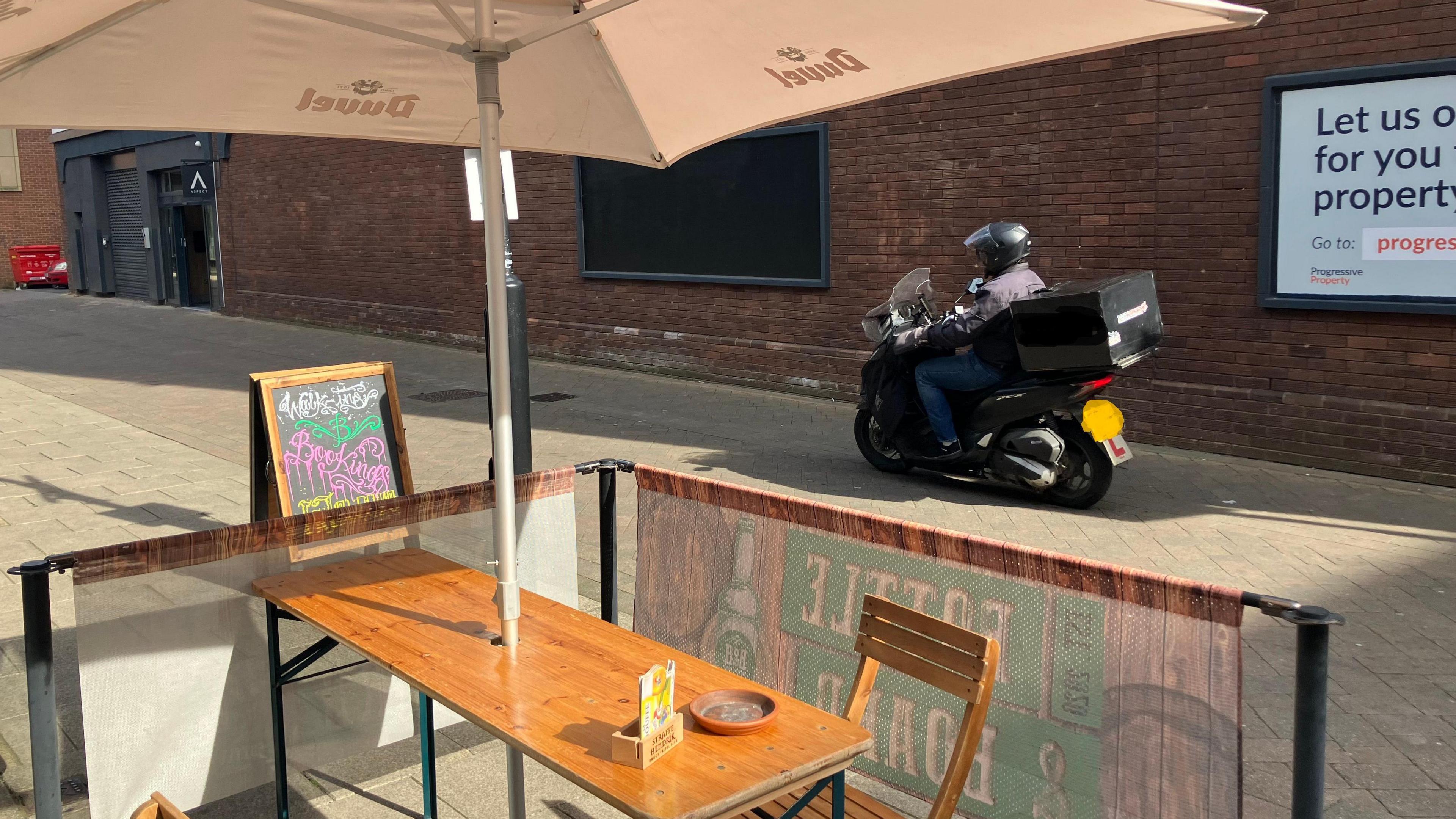 A moped riding on Wentworth Street