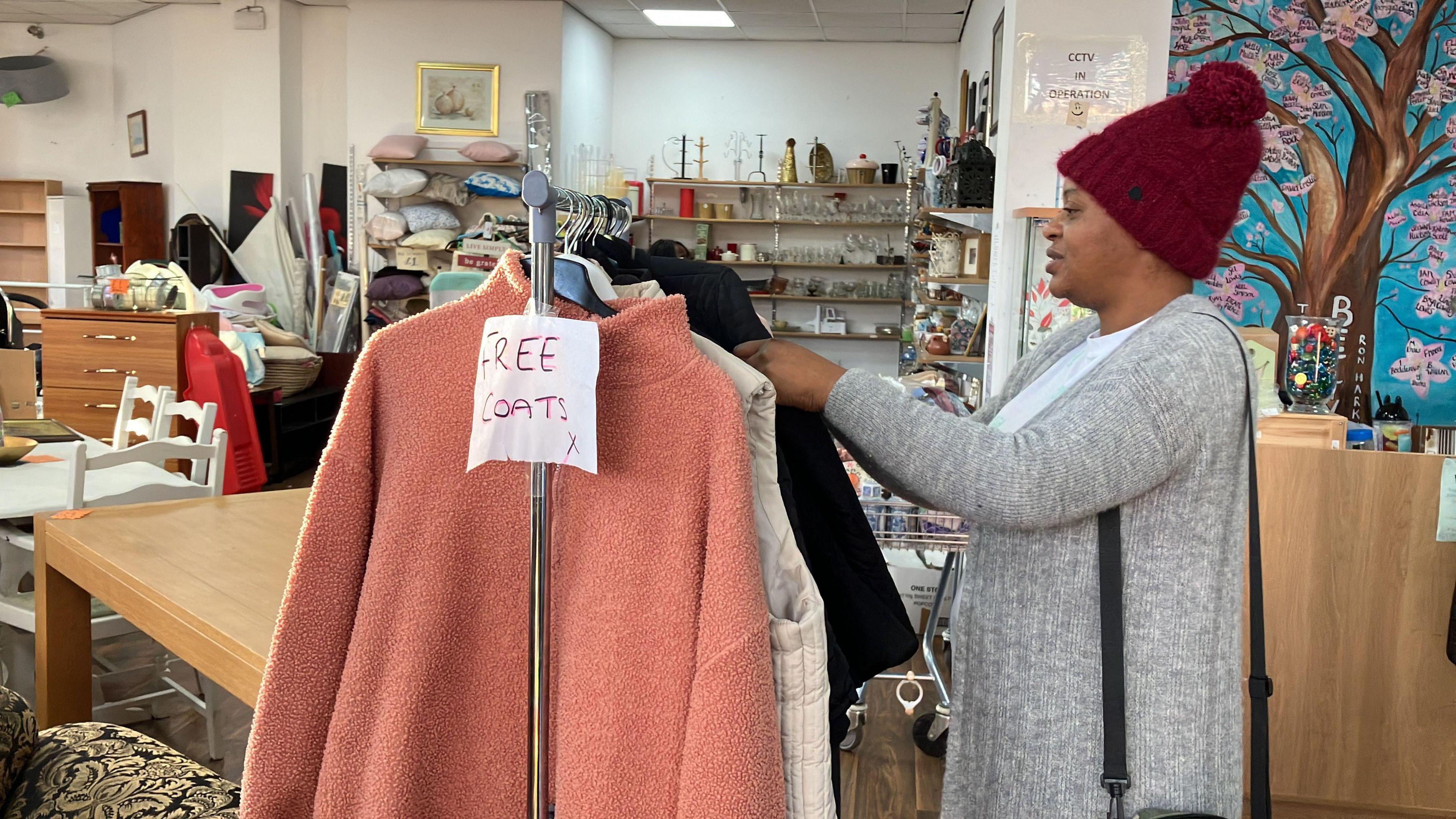 Local mum browses the rail of free coats