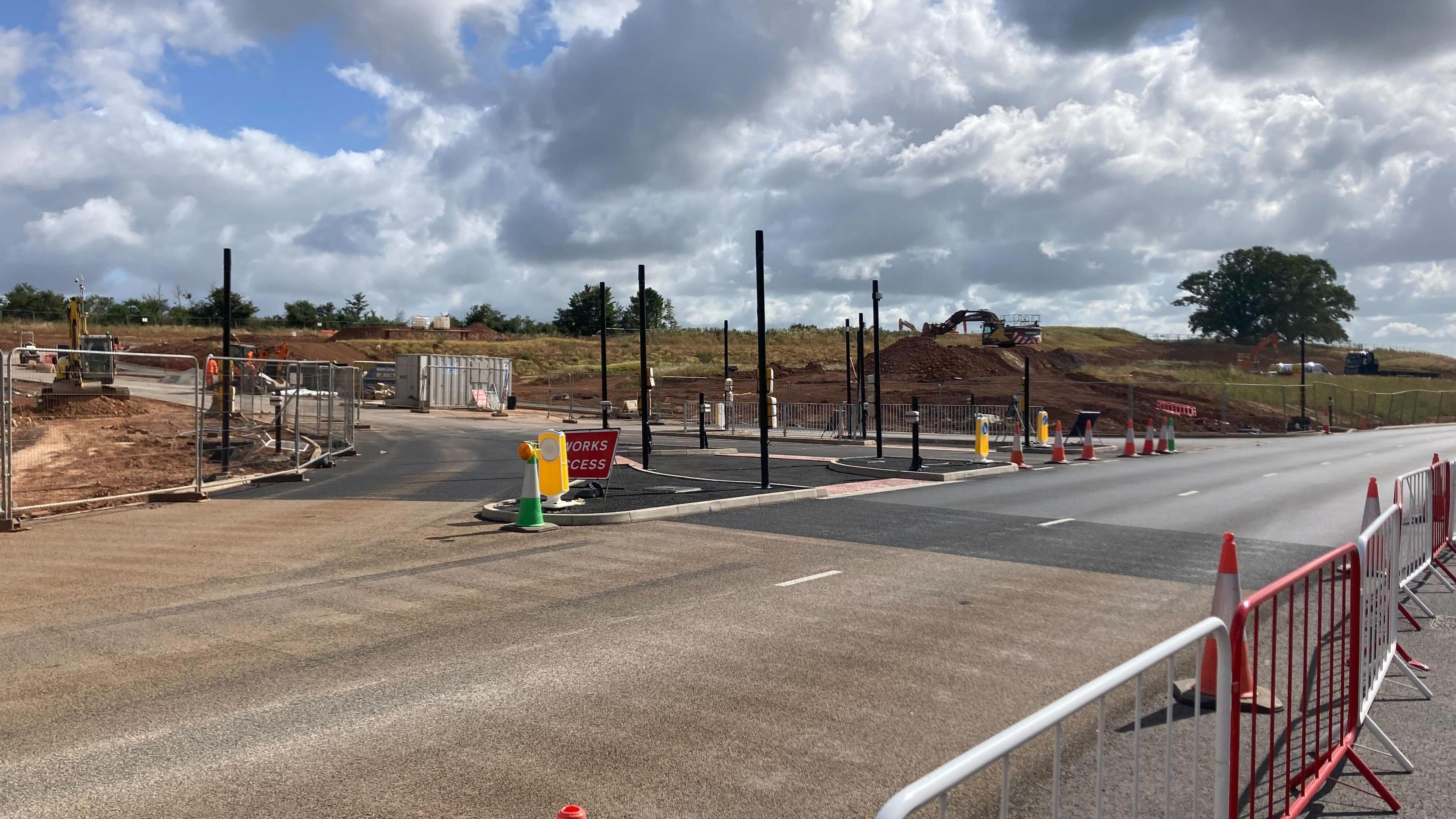 Roadworks taking place on the A39 with workers in the background.