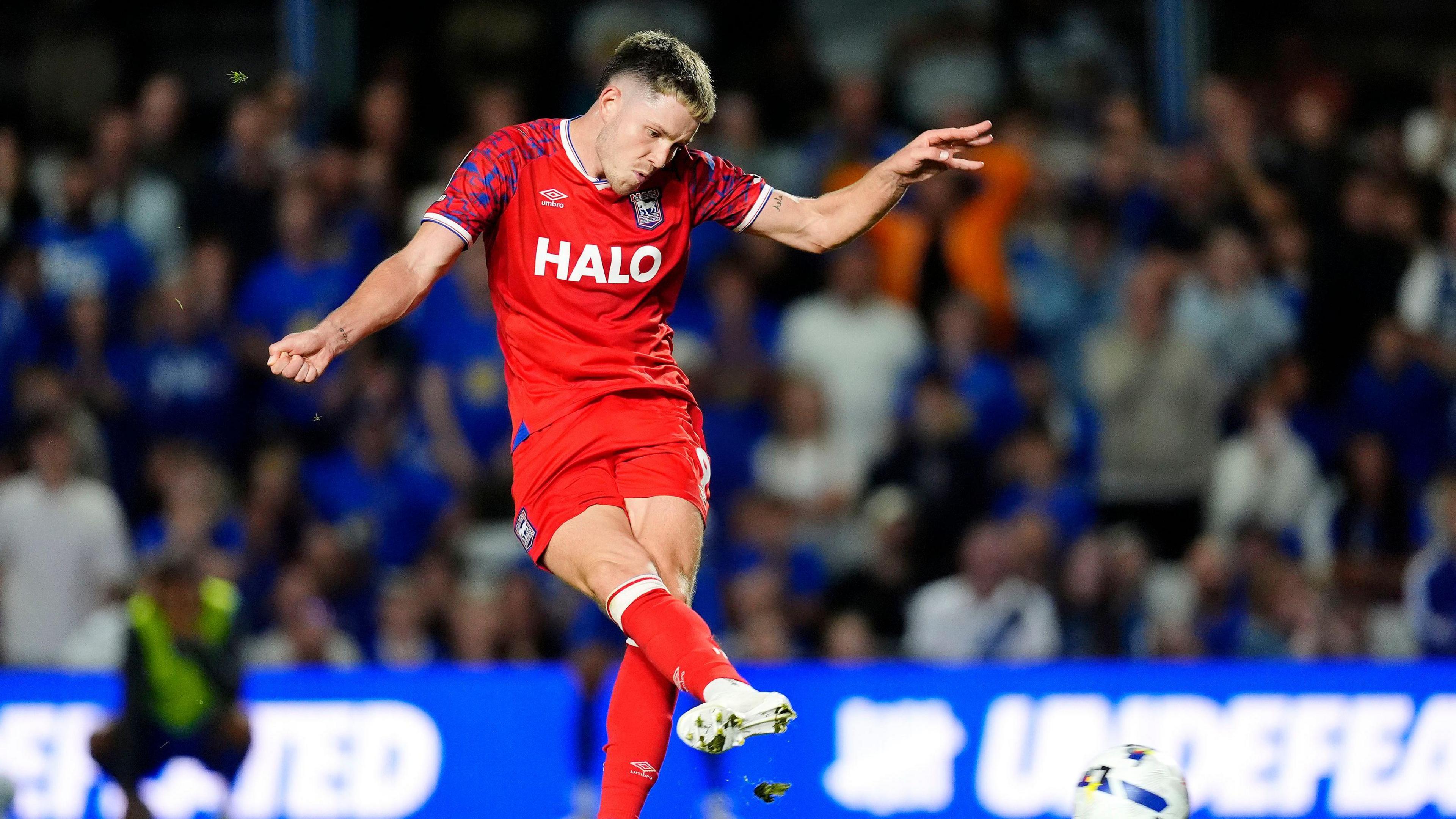 Town forward George Hirst playing in the club's red away strip
