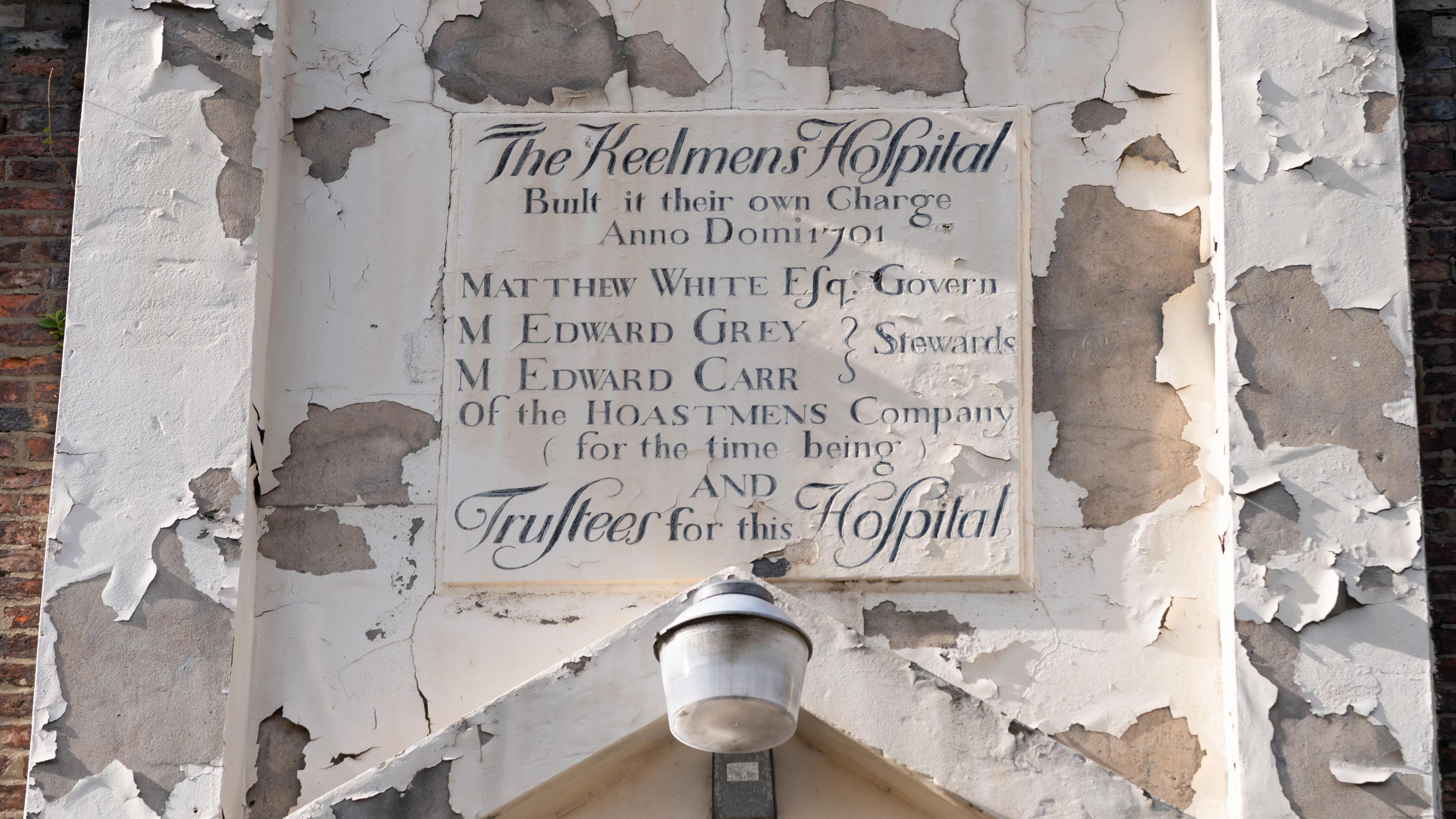 An old sign above the door that declares the hospital was built by the keelmen