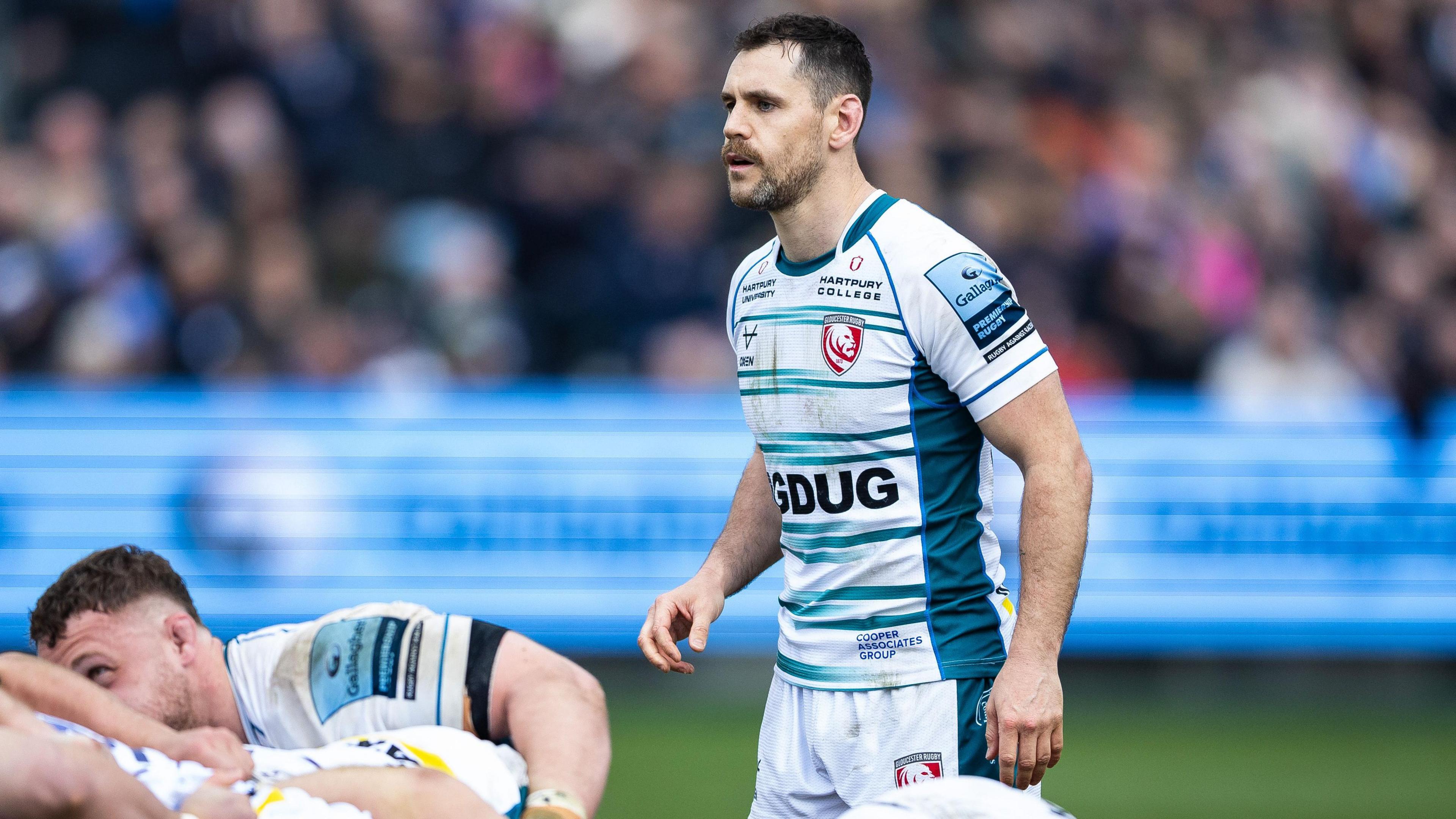 Tomos Williams standing over a scrum while playing for Gloucester