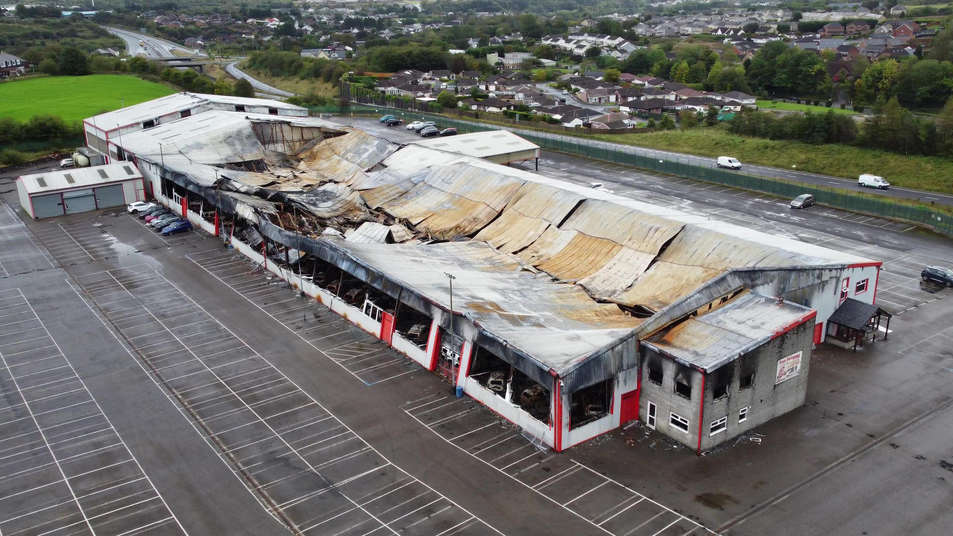 The Ron Skinner and Sons building in Tredegar, severely damaged by fire with the roof falling inwards and black around what were the windows.