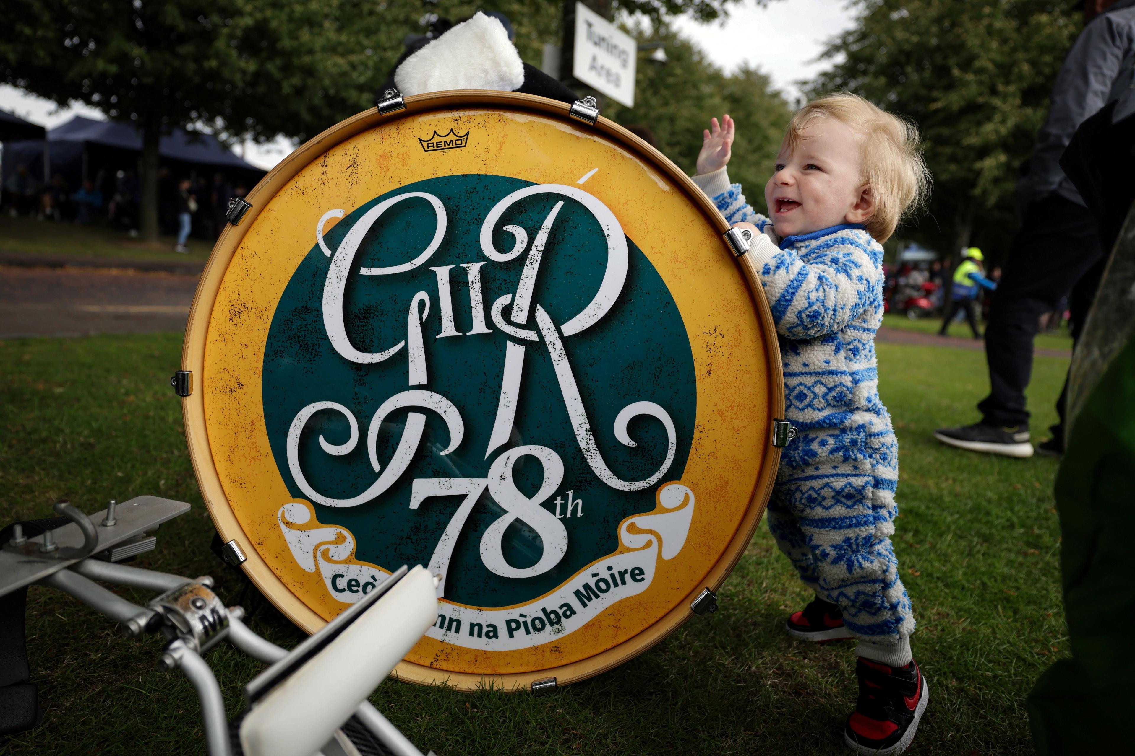 Celebrating his first birthday, one-year-old Nicholas Bellia from Canada plays with his father's drum