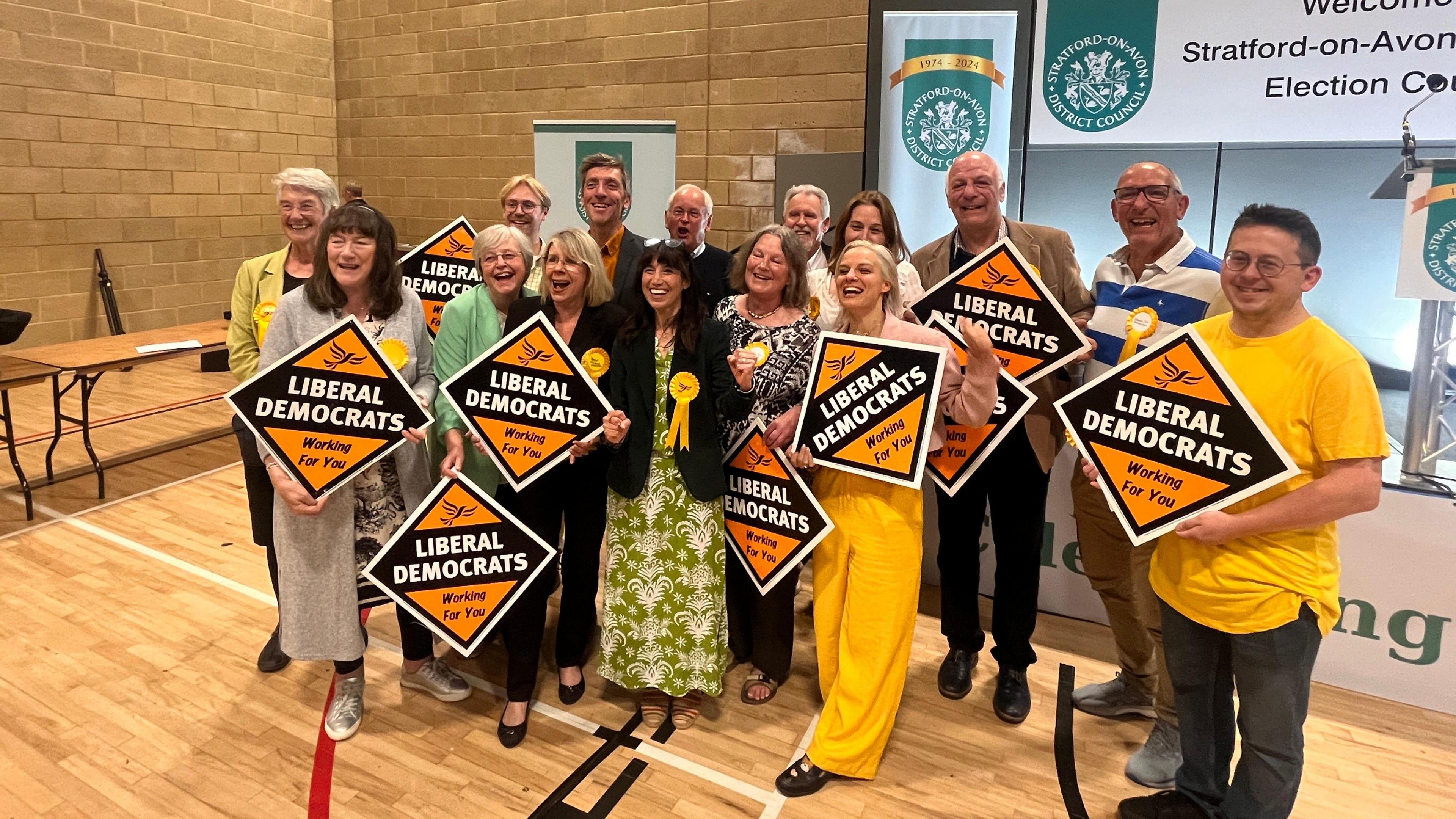 Manuella Pertegella and supporters holding Liberal Democrat placards