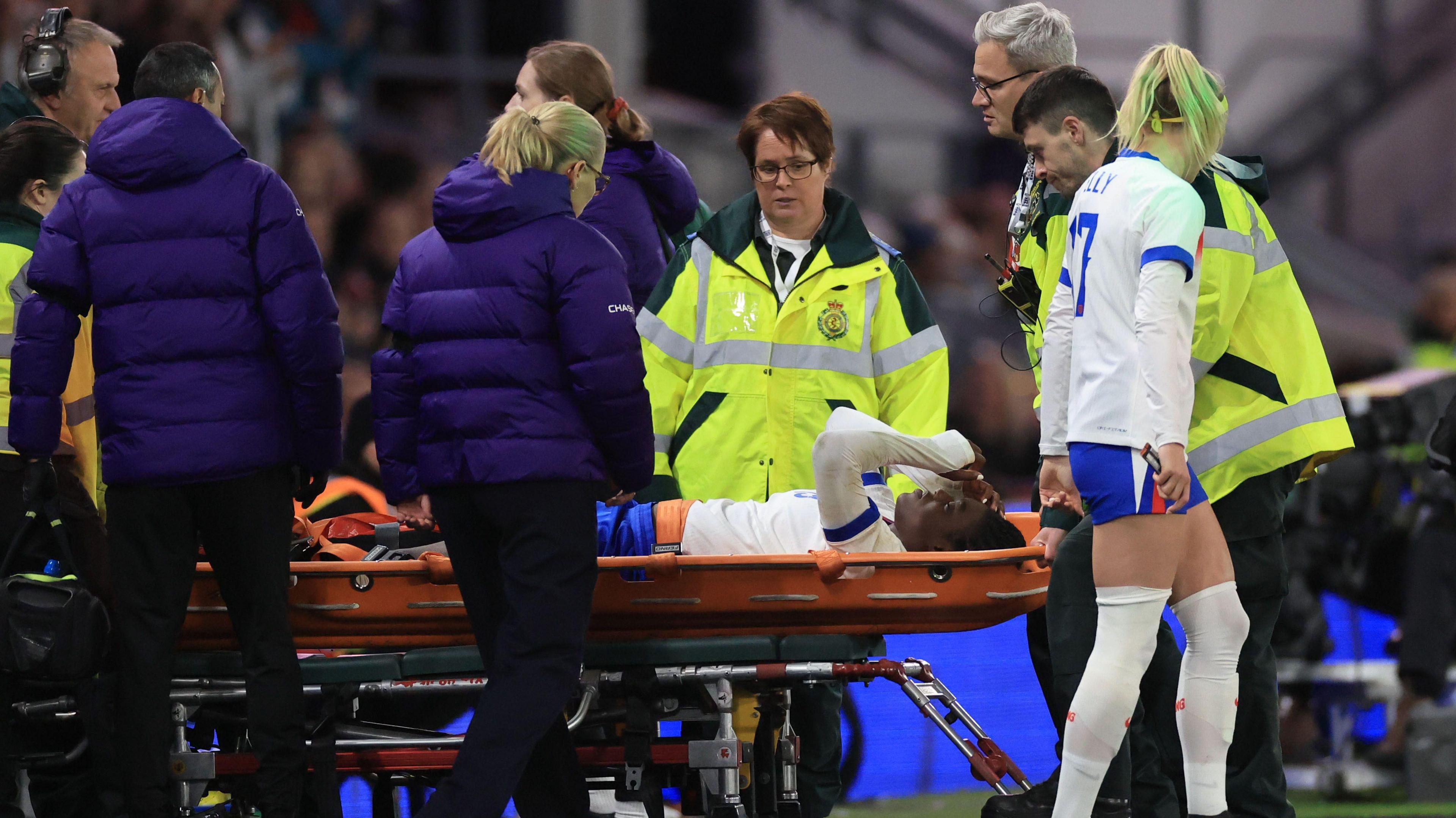 Michelle Agyemang of England leaves the game injured on a stretcher