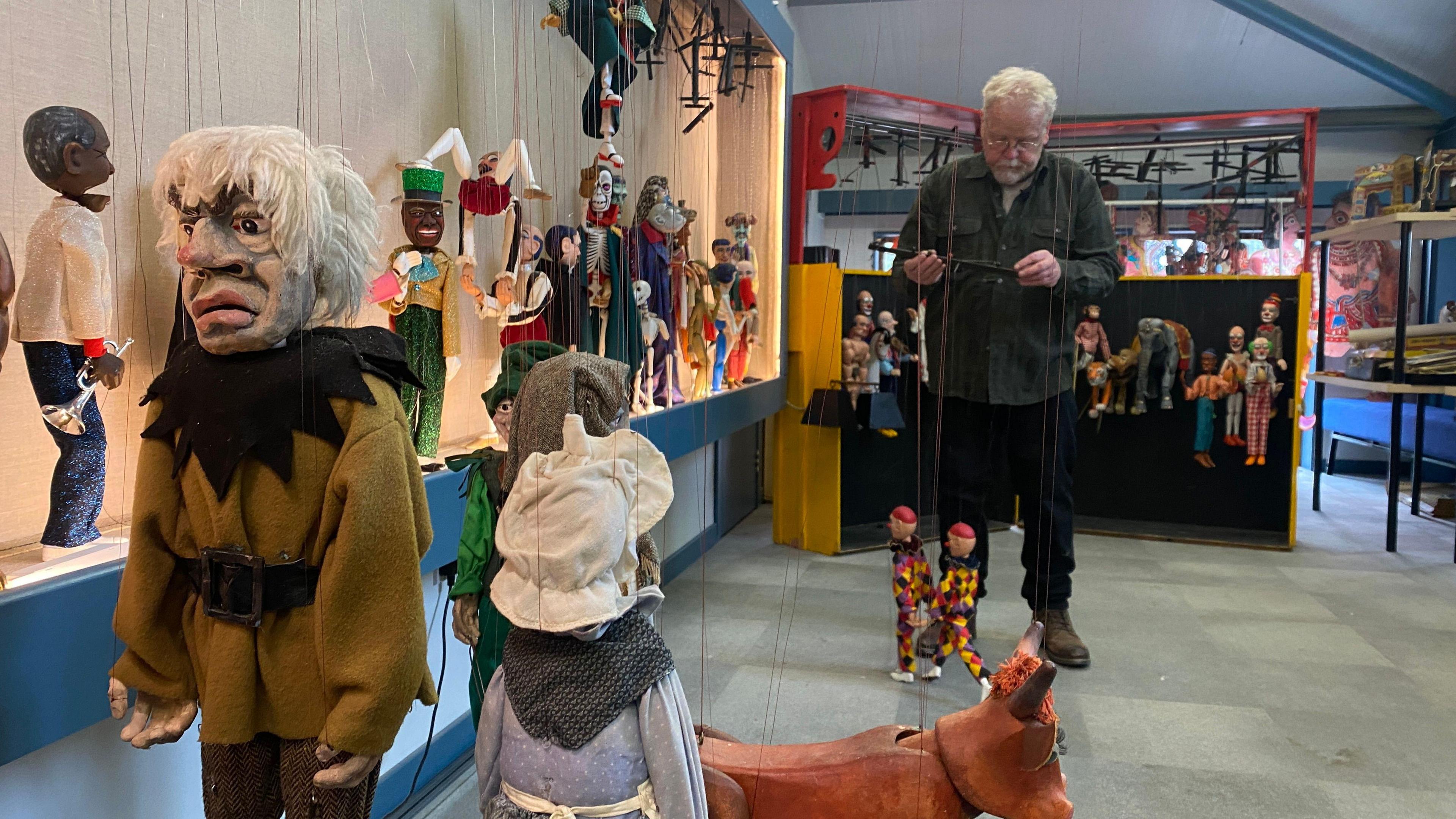 John Parkinson operating some puppets at the Upfront puppet museum.