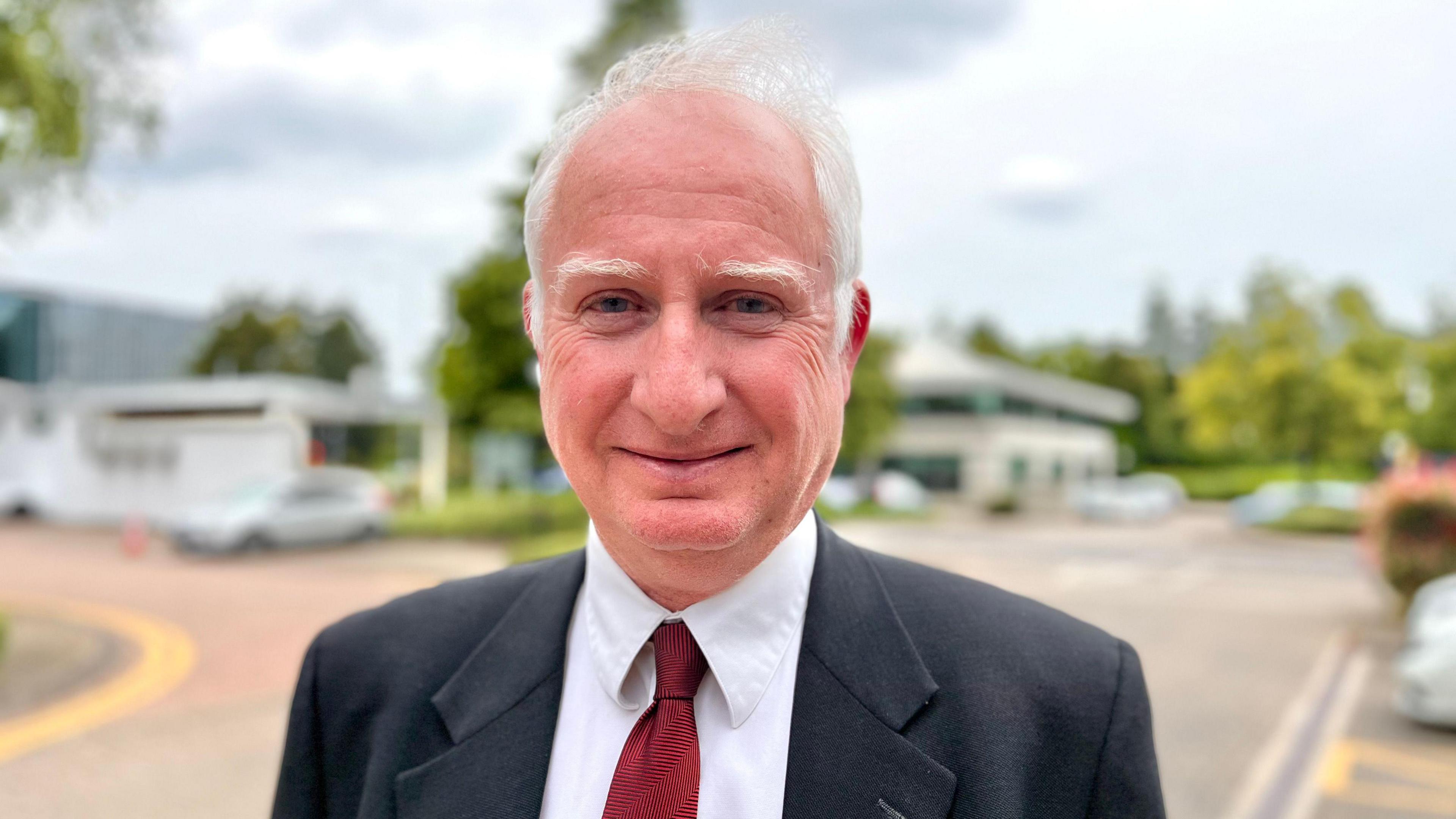 Farming minister Daniel Zeichner wearing a suit smiles for the camera  