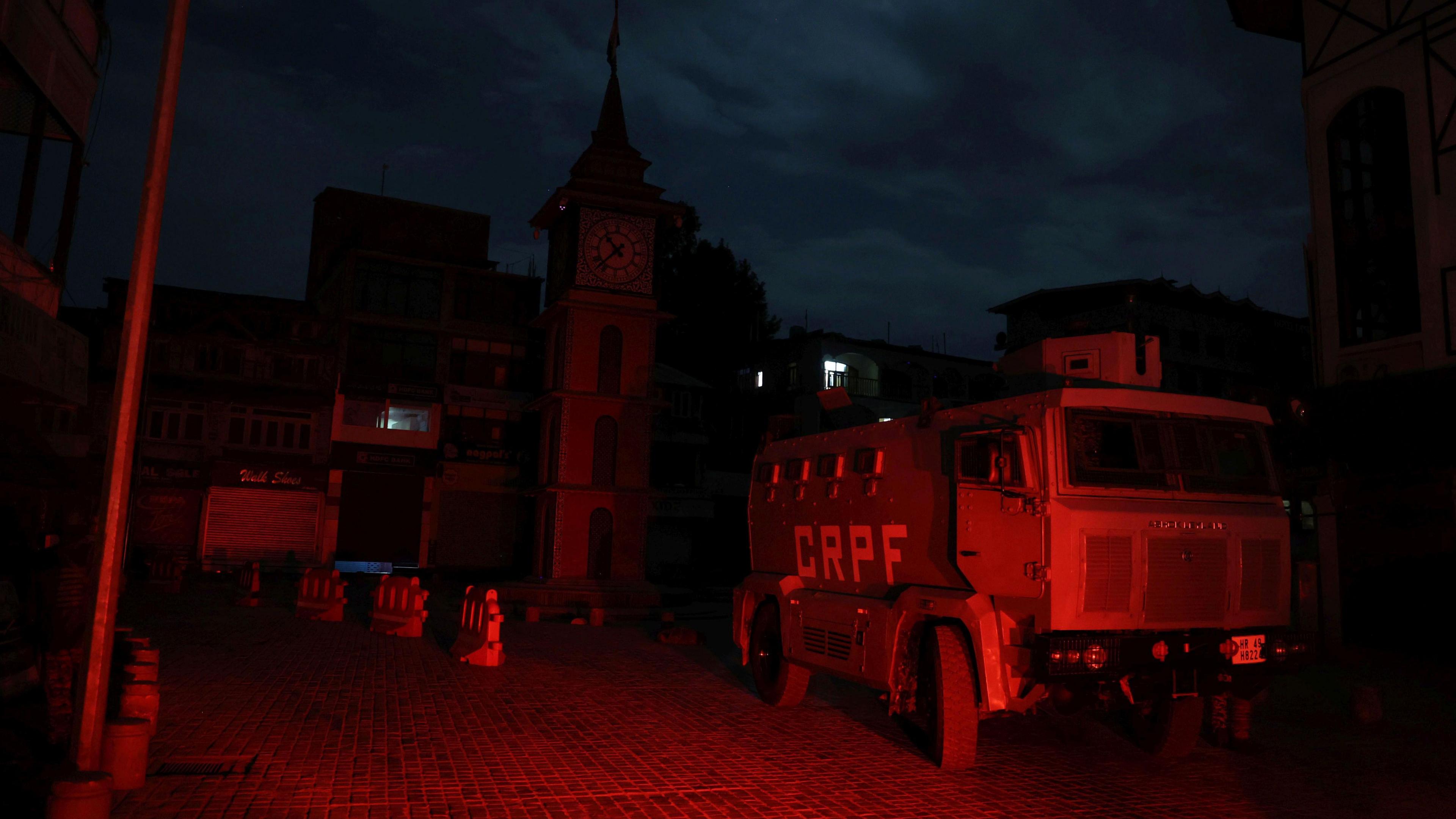 A police truck in a darkened area of Srinigar during a city-wide blackout in the wider Jammu region.