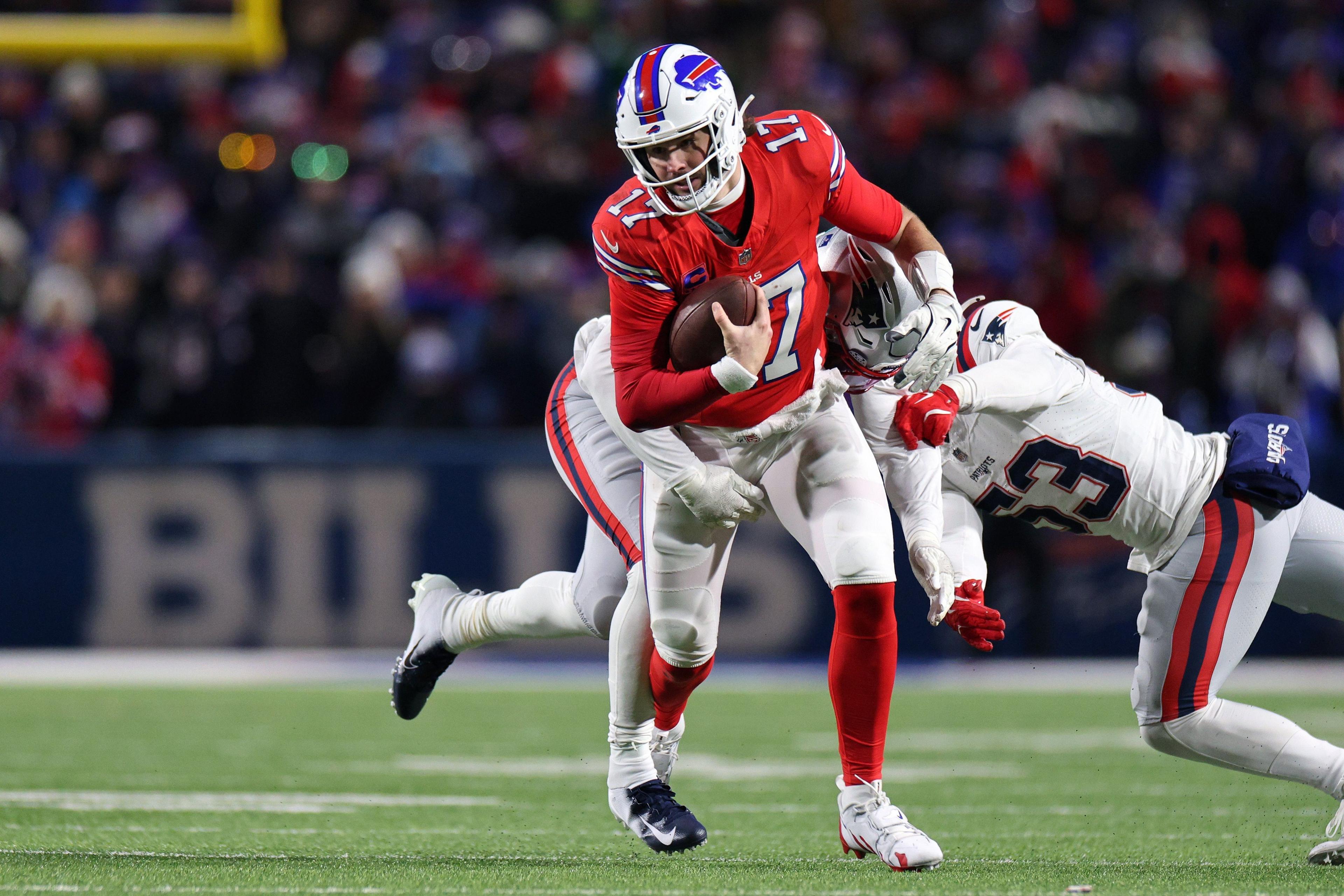 Josh Allen of the Buffalo Bills runs with the ball against the New England Patriots