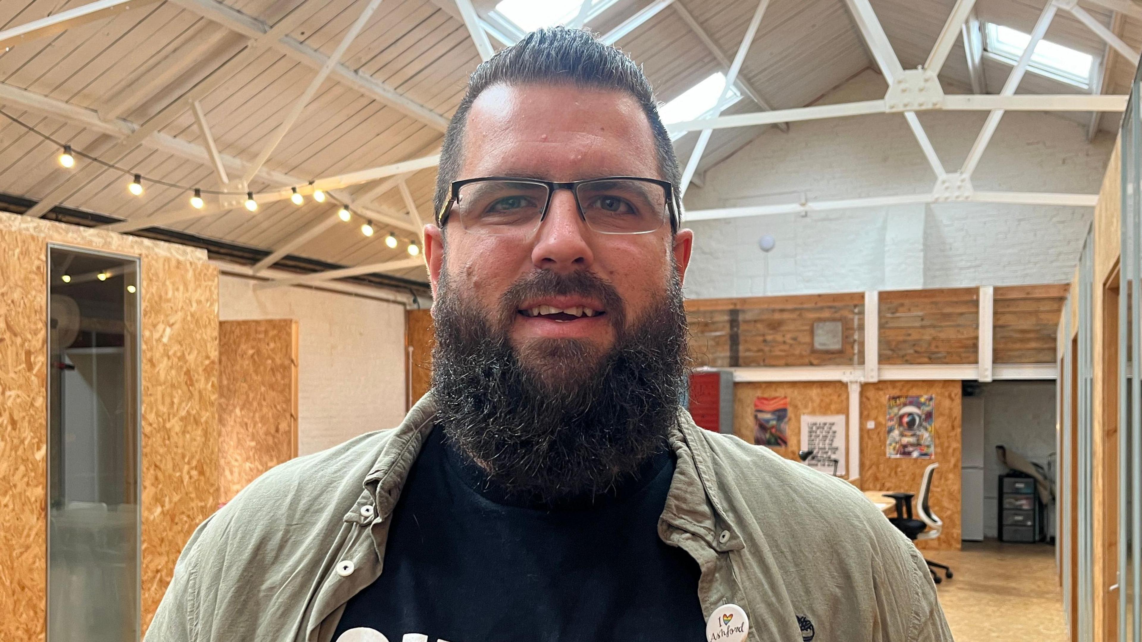 Man  with short black hair and a long black beard