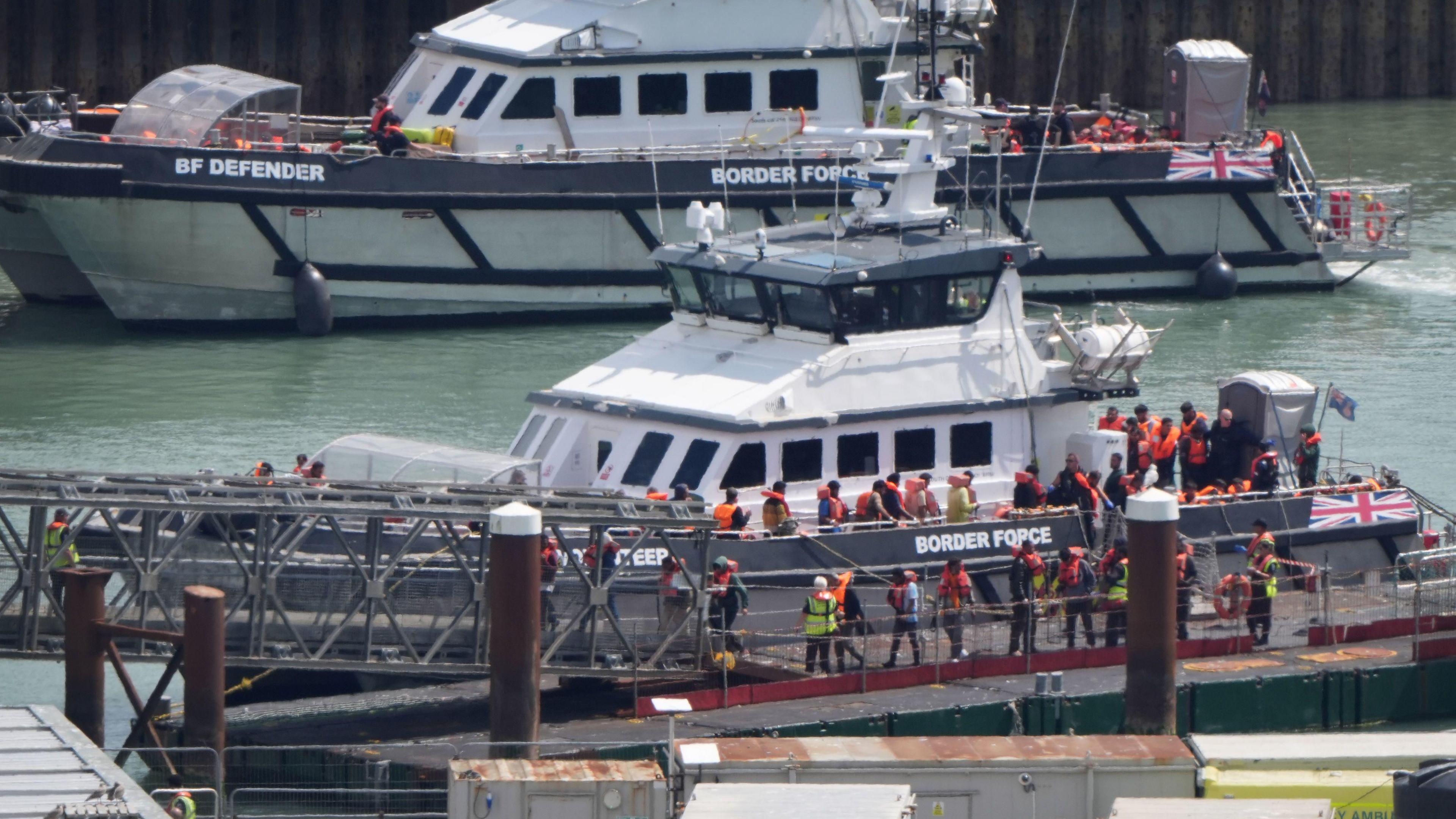 A group of people thought to be migrants are brought in to the Border Force compound in Dover, Kent, from two Border Force vessels following a small boat incident in the Channel.
