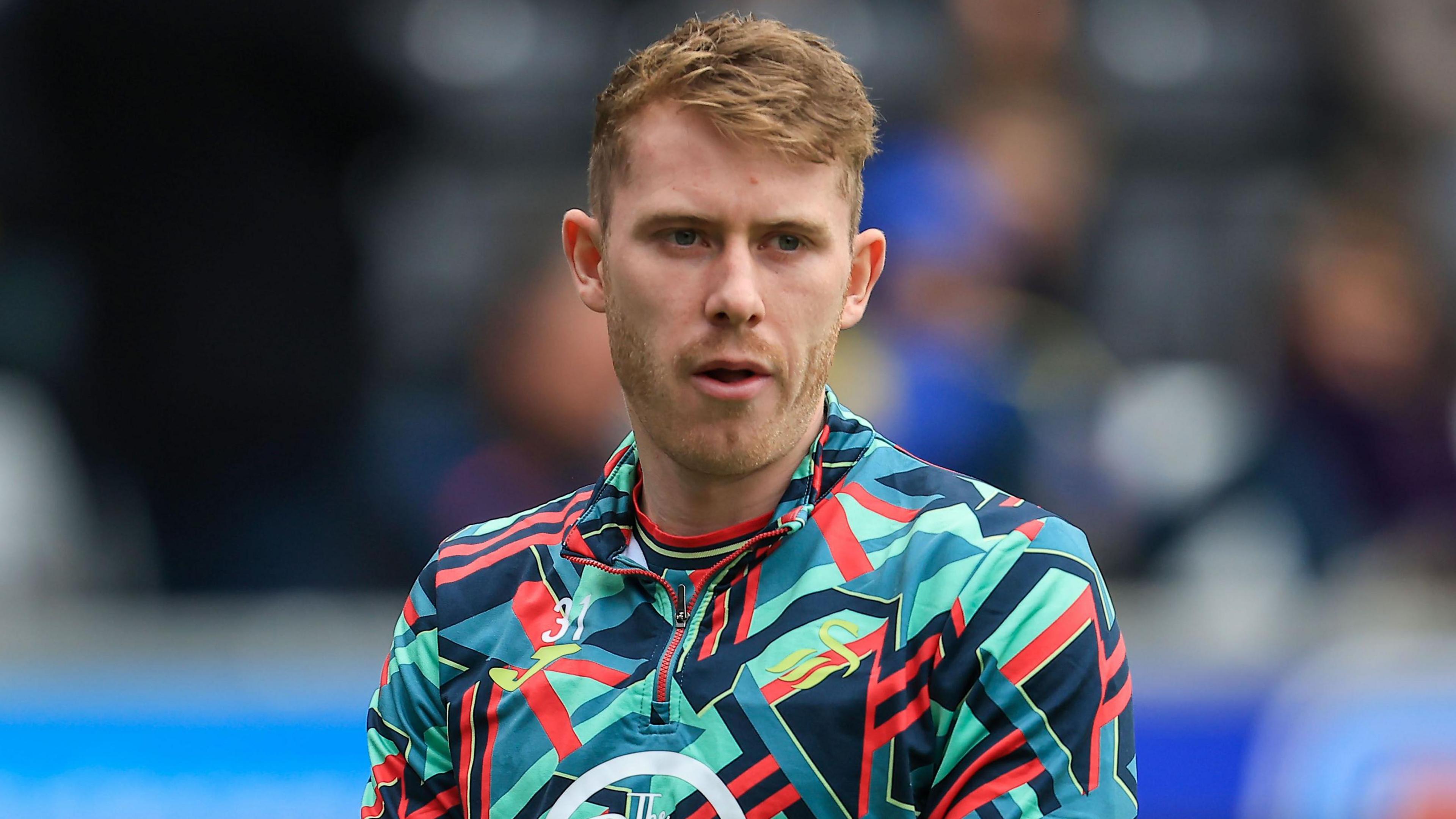 Ollie Cooper warming up before a Swansea game in March 