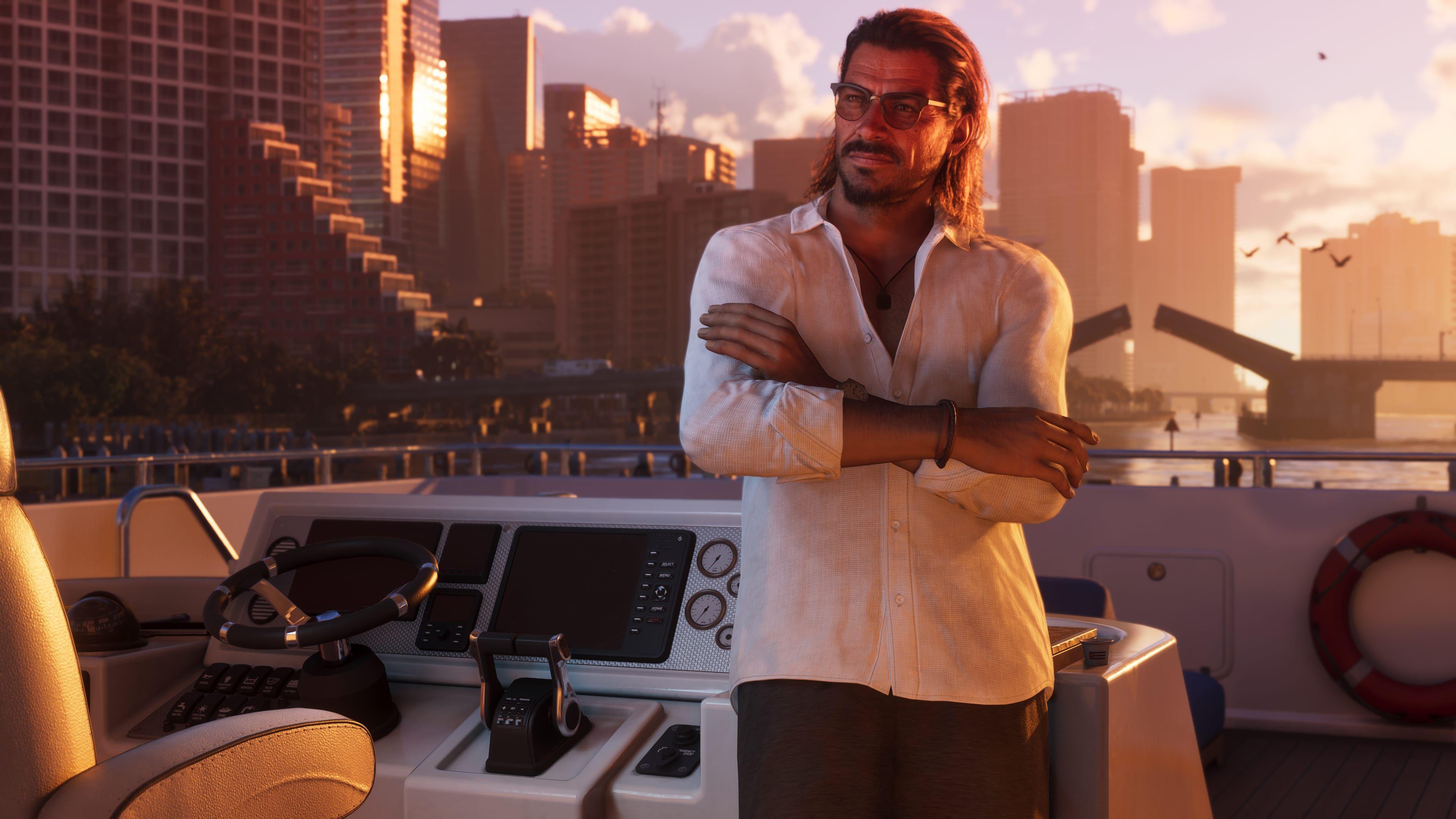 A male character from GTA 6 in an open-collared shirt with slicked-back hair and sunglasses leans, arms folded, against the controls of a yacht as it coasts down a waterway flanked by skyscrapers. A road bridge opens in the distance as orange dawn light reflects of the glass fronts of the tall buildings. The computer-generated image is convincingly lifelike.