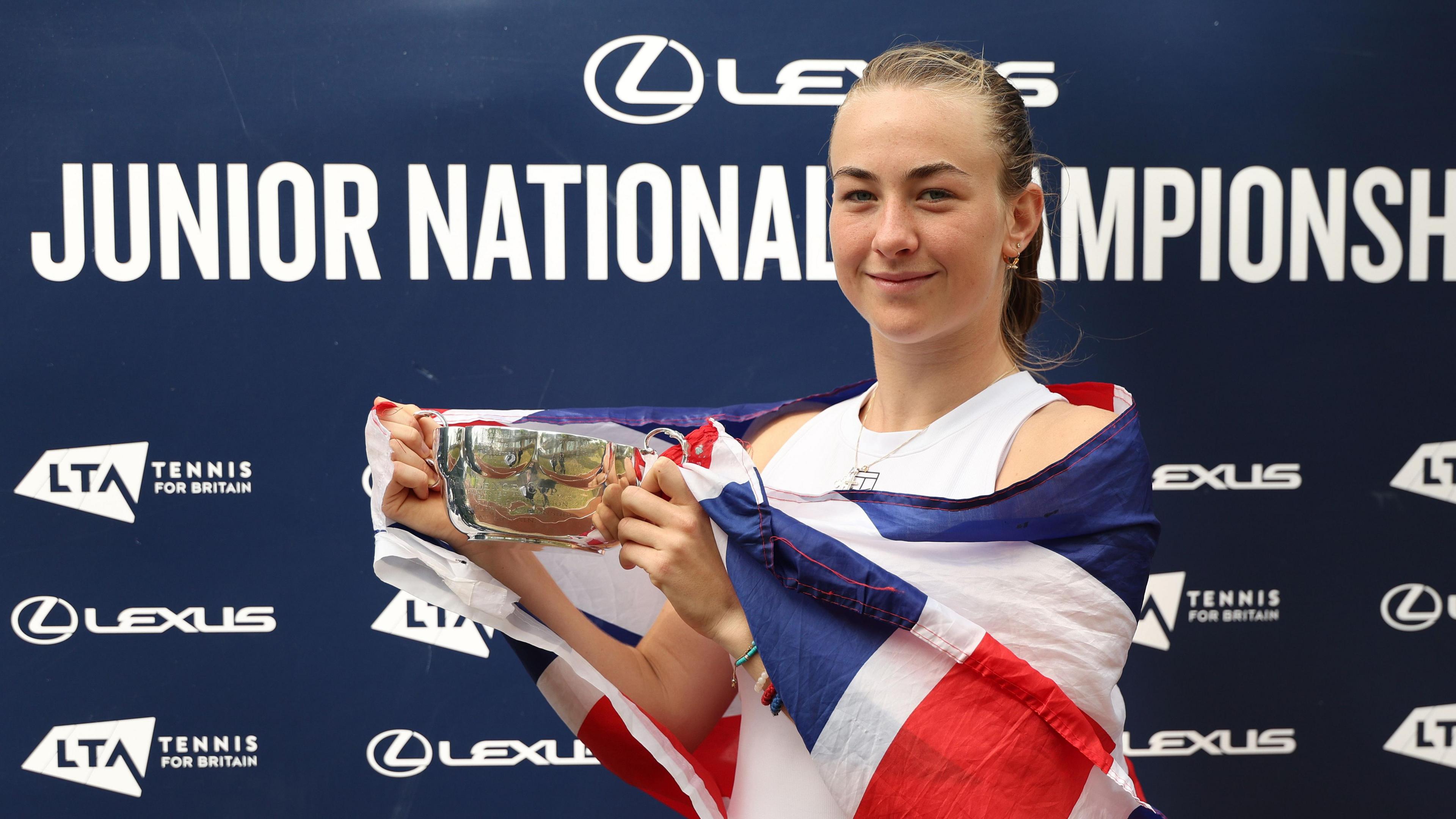 Mika Stojsavljevic lifts the girls' singles trophy at the British national junior championships