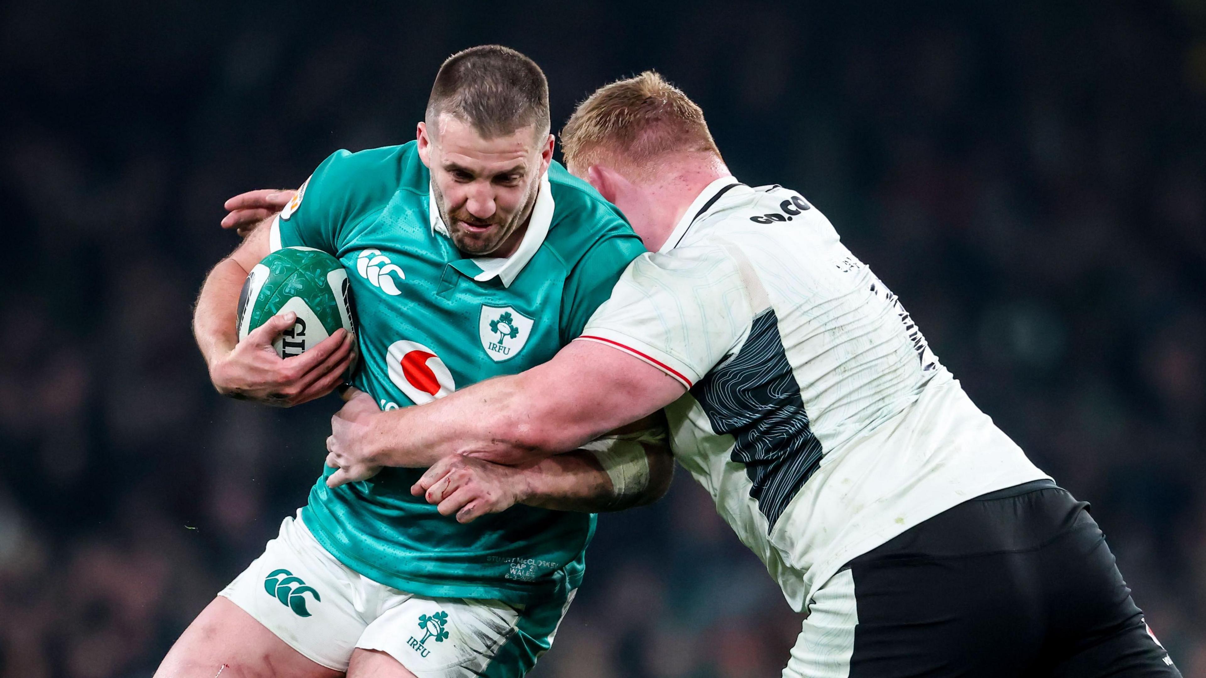 Stuart McCloskey in action for Ireland against Wales with the ball under his right arm