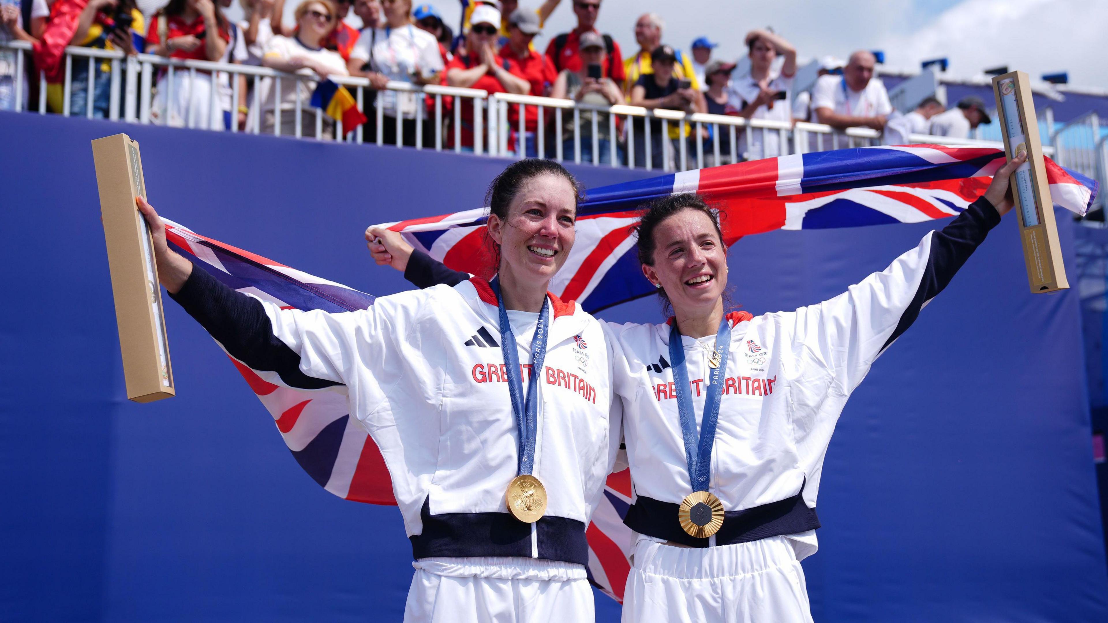 Great Britain's Emily Craig (left) and Imogen Grant (right) celebrate with their gold medals during the ceremony for the Rowing Lightweight Women's Double Sculls Finals at the Vaires-sur-Marne Nautical Stadium on the seventh day of the 2024 Paris Olympic Games in France.