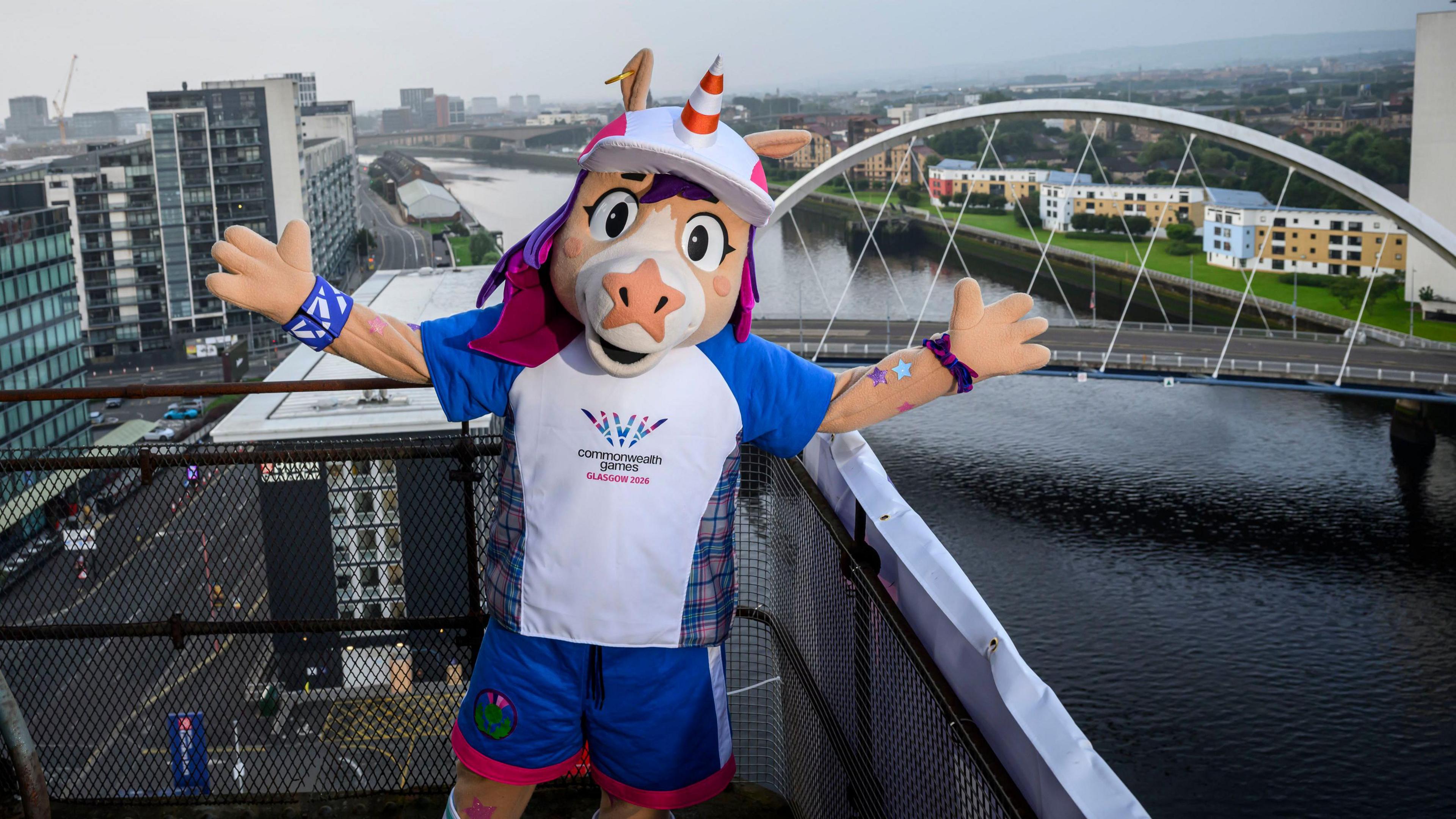 a unicorn mascot on a crane overlooking the river clyde