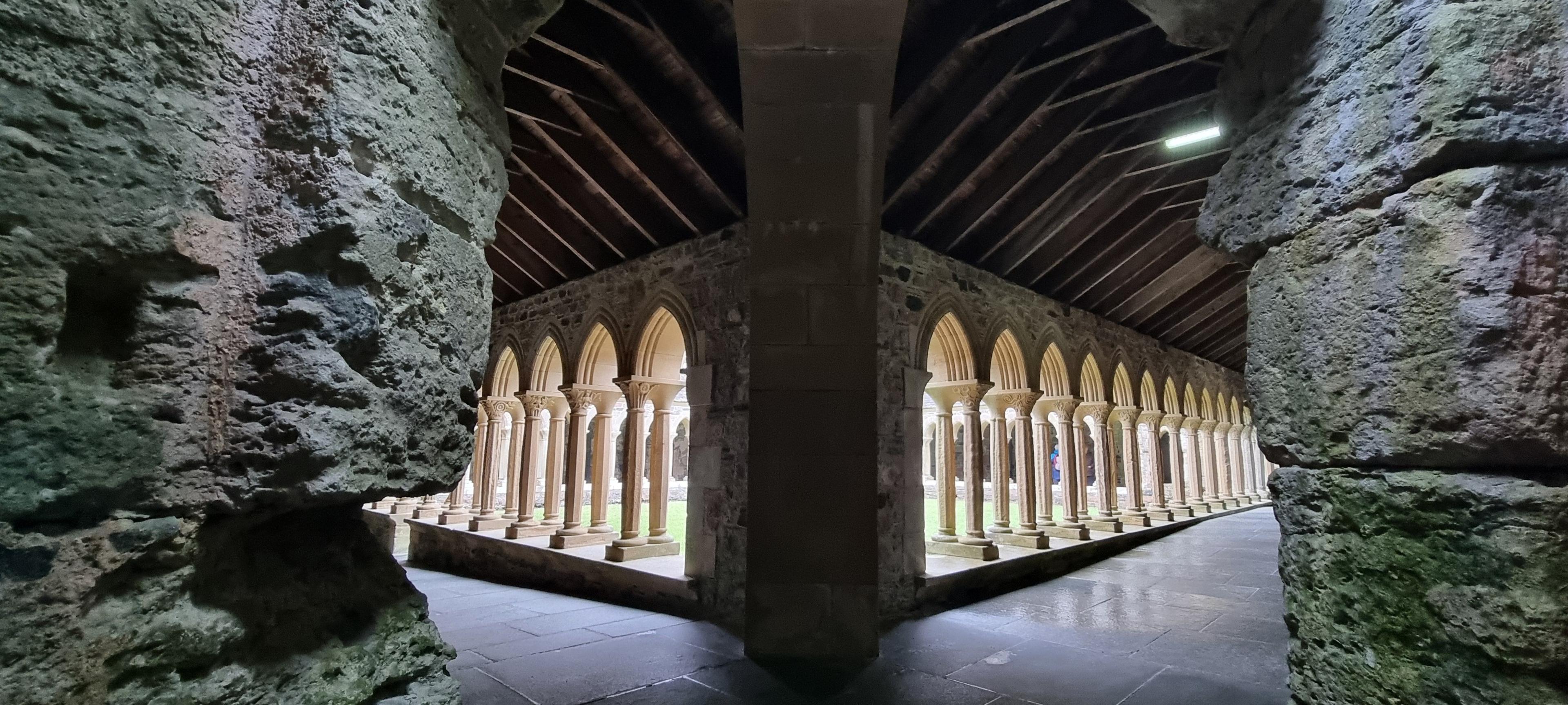 Panoramic image of arches in the Abbey, framed by old stone walls