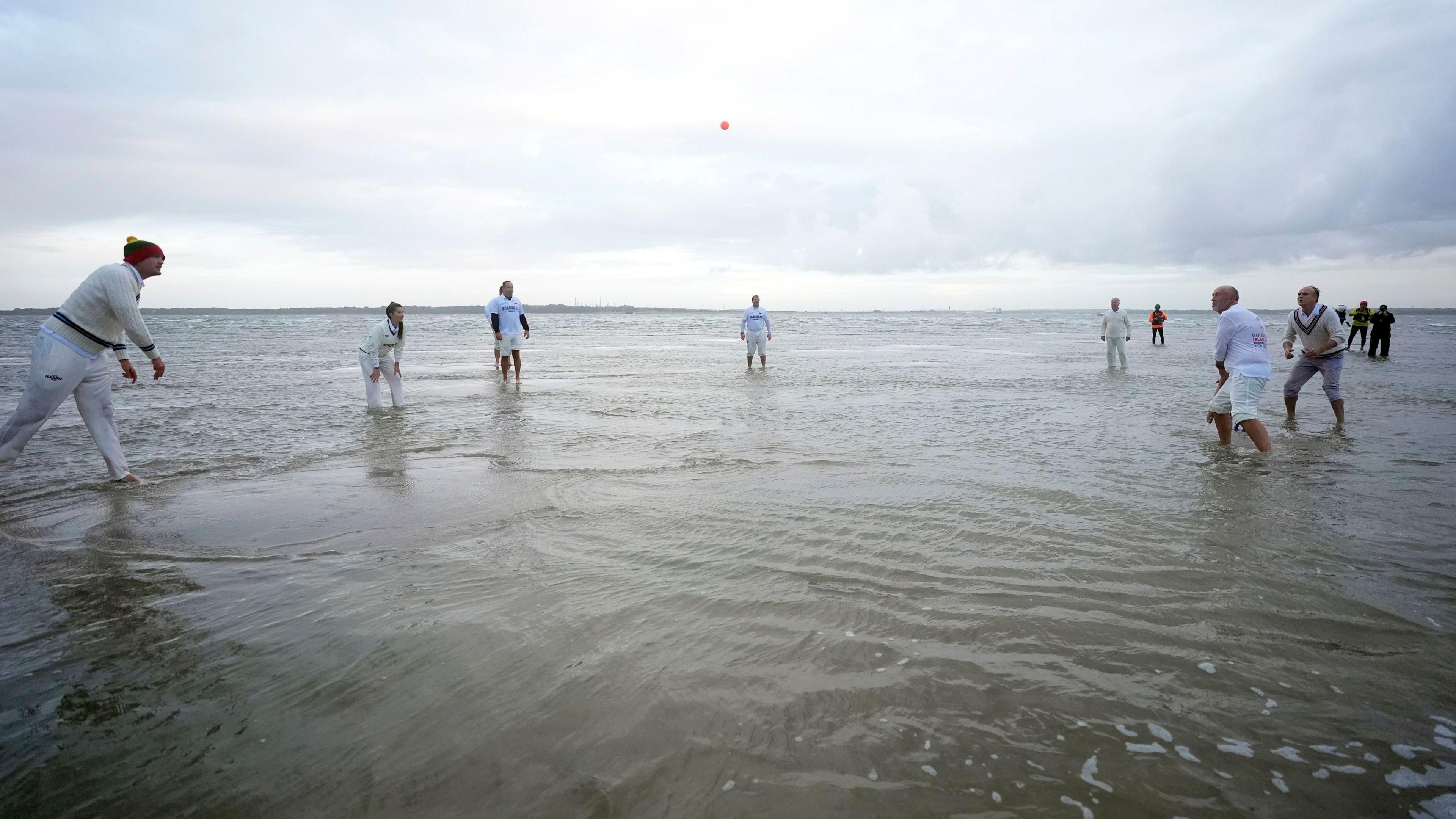 Members of the Royal Southern Yacht Club and the Island Sailing Club take part in the annual Brambles cricket match on the Bramble Bank sandbank in the middle of the Solent at low tide.