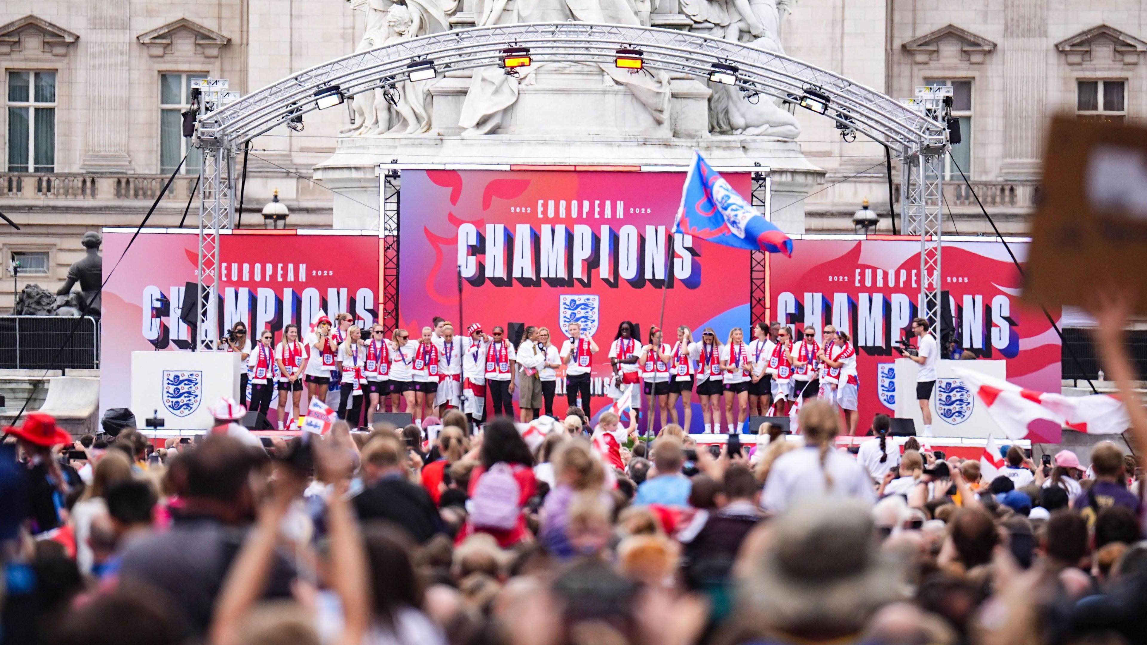 England players on stage during a Homecoming Victory Parade