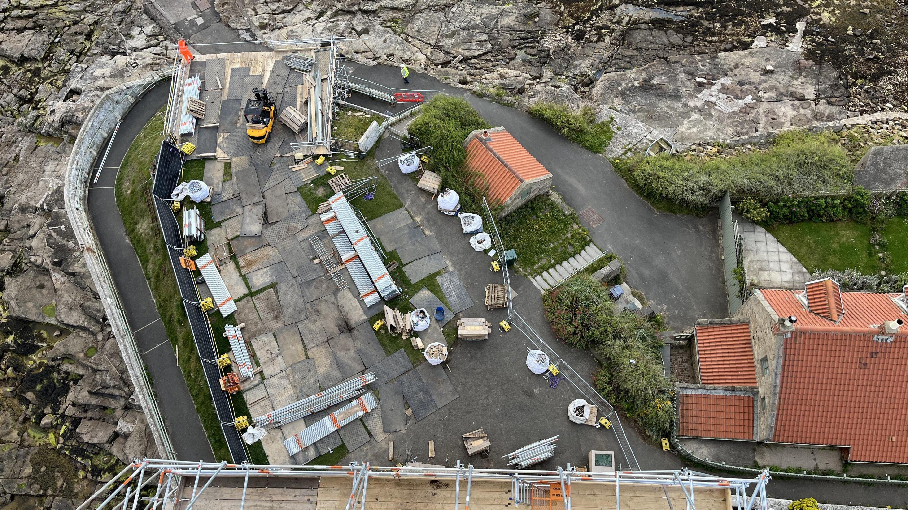 Aerial view of construction work on a lighthouse and island.